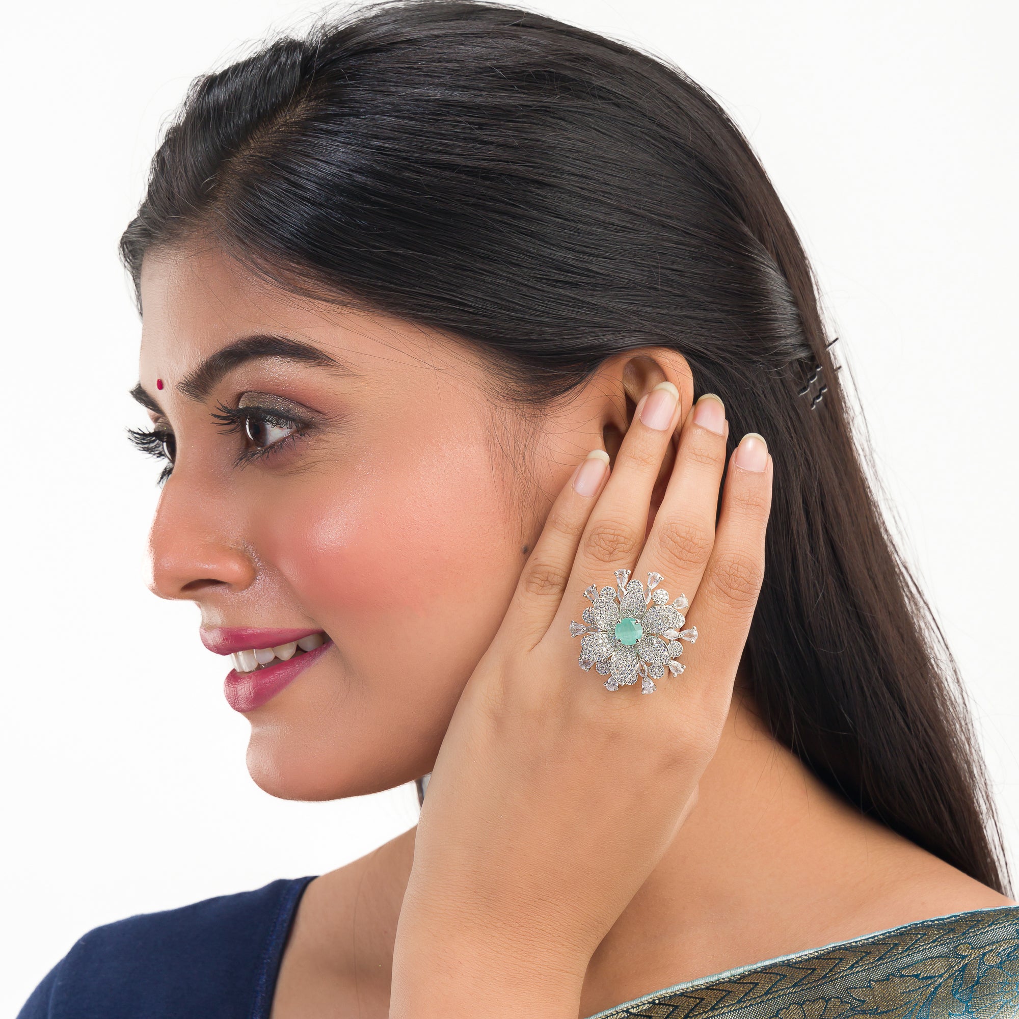 Aqua zircon floral finger ring in silver brings a fresh, vibrant charm to your party style.