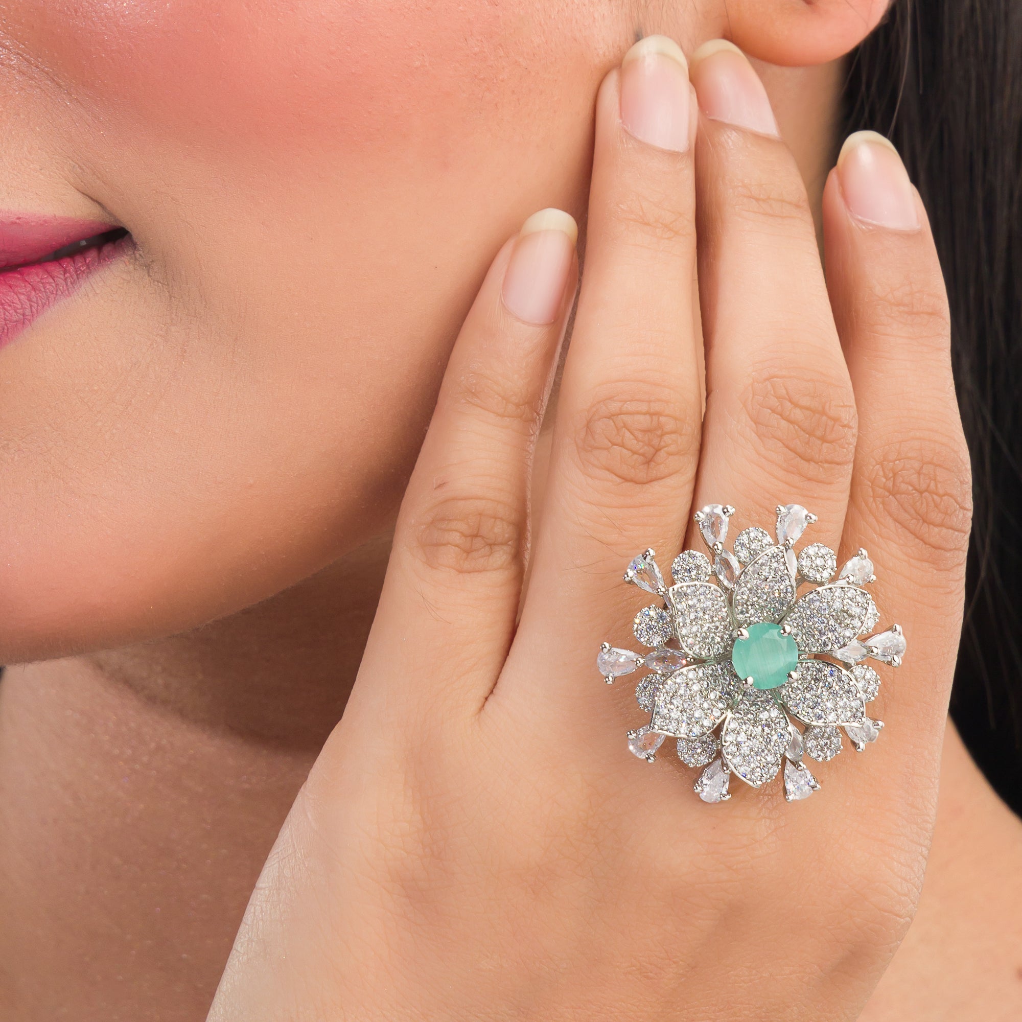 Aqua zircon floral finger ring in silver brings a fresh, vibrant charm to your party style.