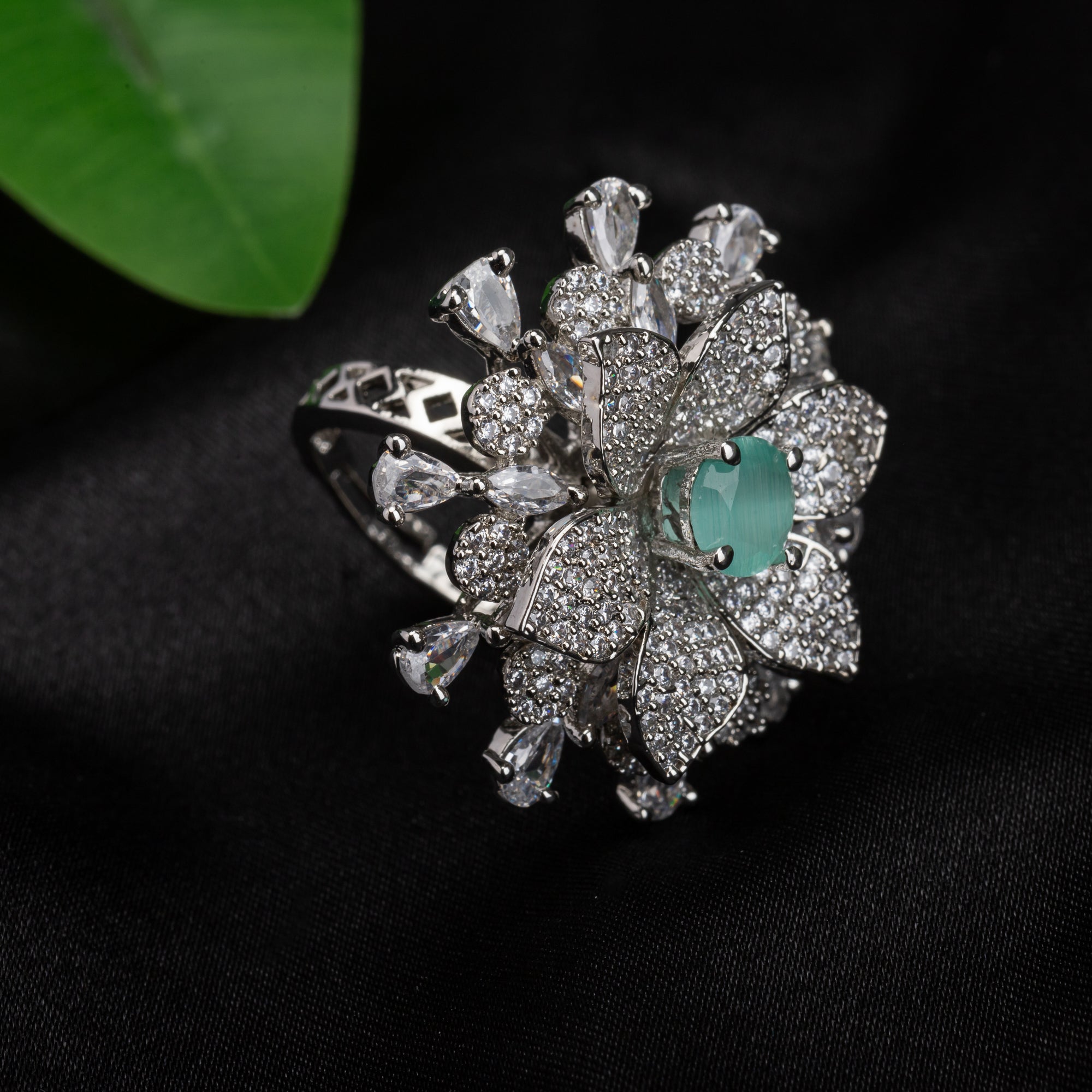 Aqua zircon floral finger ring in silver brings a fresh, vibrant charm to your party style.