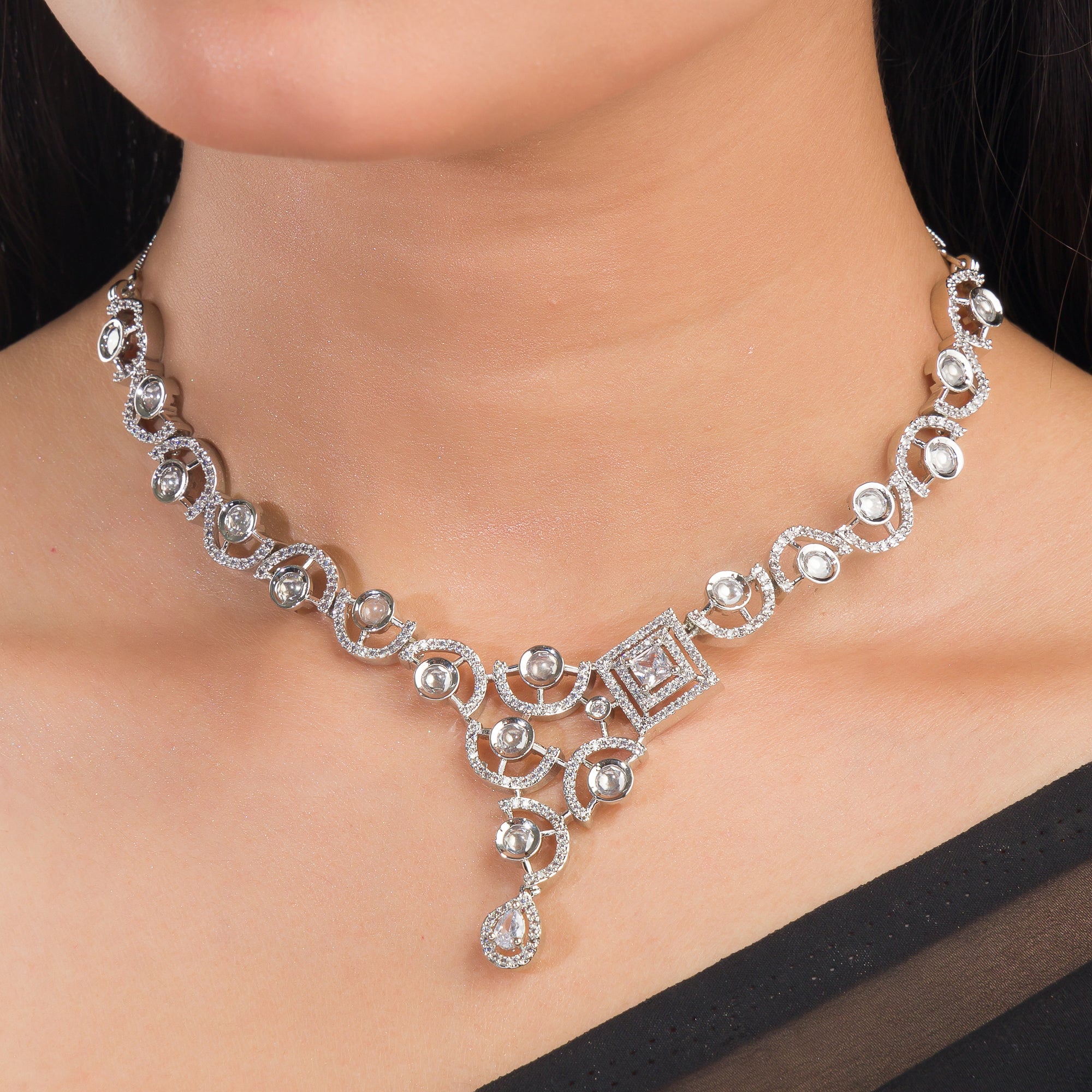 Sleek and elegant white zircon-studded necklace set for a refined party look.