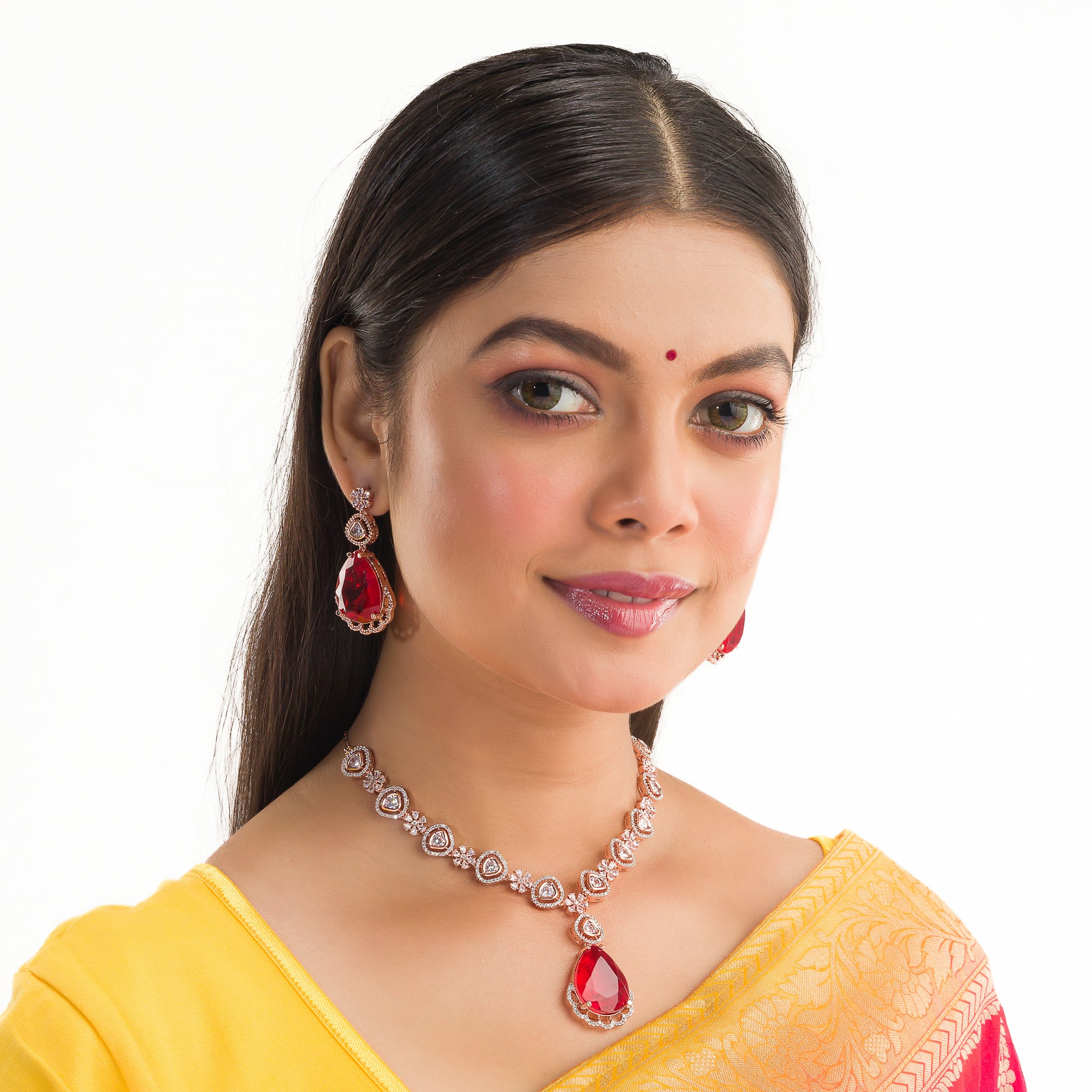 Rose gold necklace set with red stones and zircon accents for a bold and elegant party look.