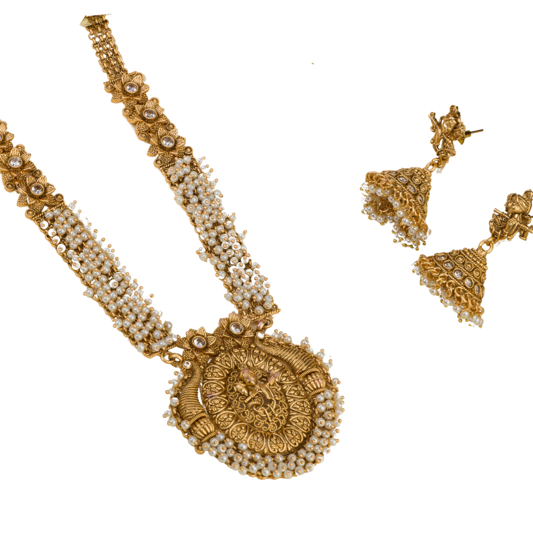 Golden Radha Krishna long necklace set with pearls and matching jhumkas for a divine festive look.