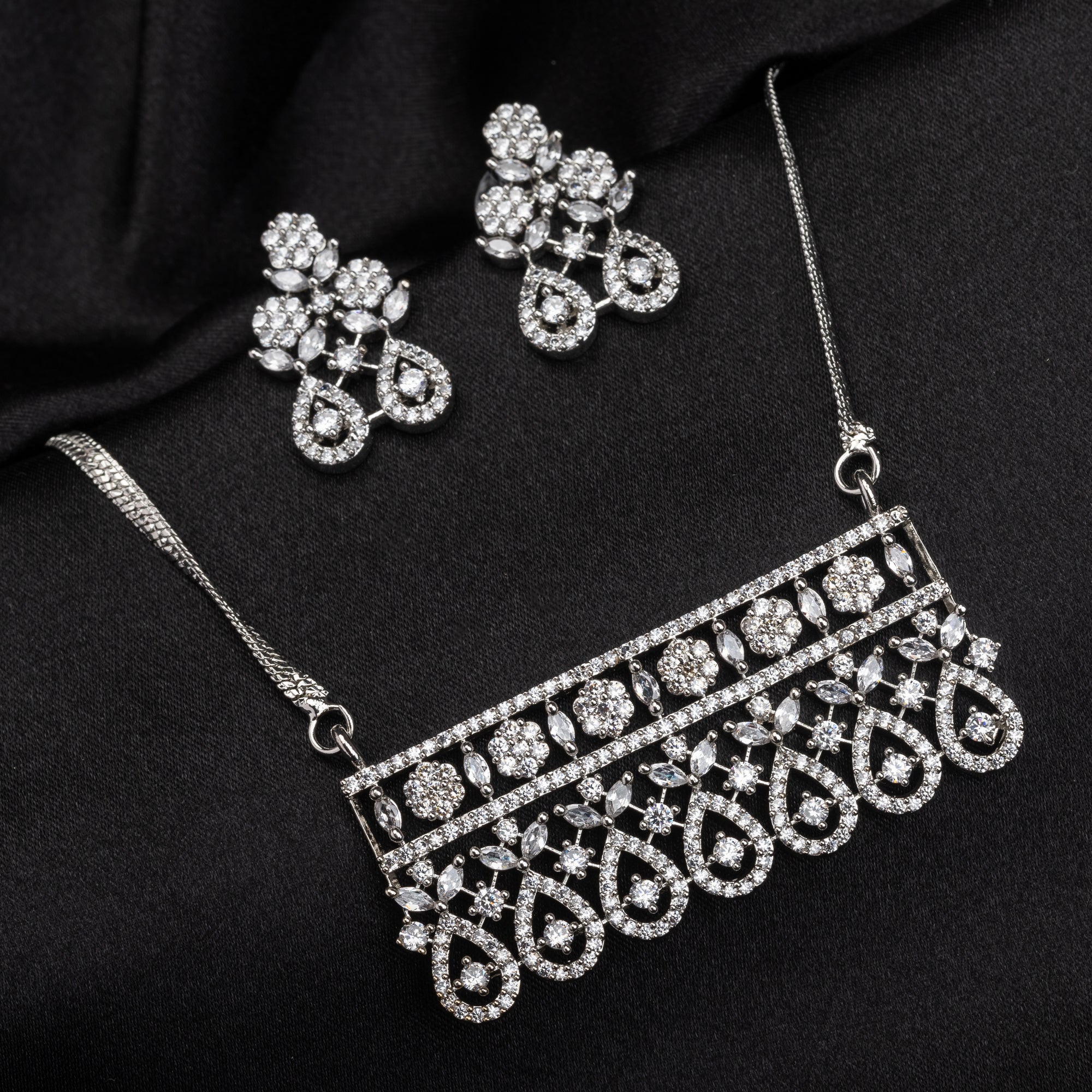 Festive silver zircon pendant set with matching earrings, offering refined elegance and luxury.