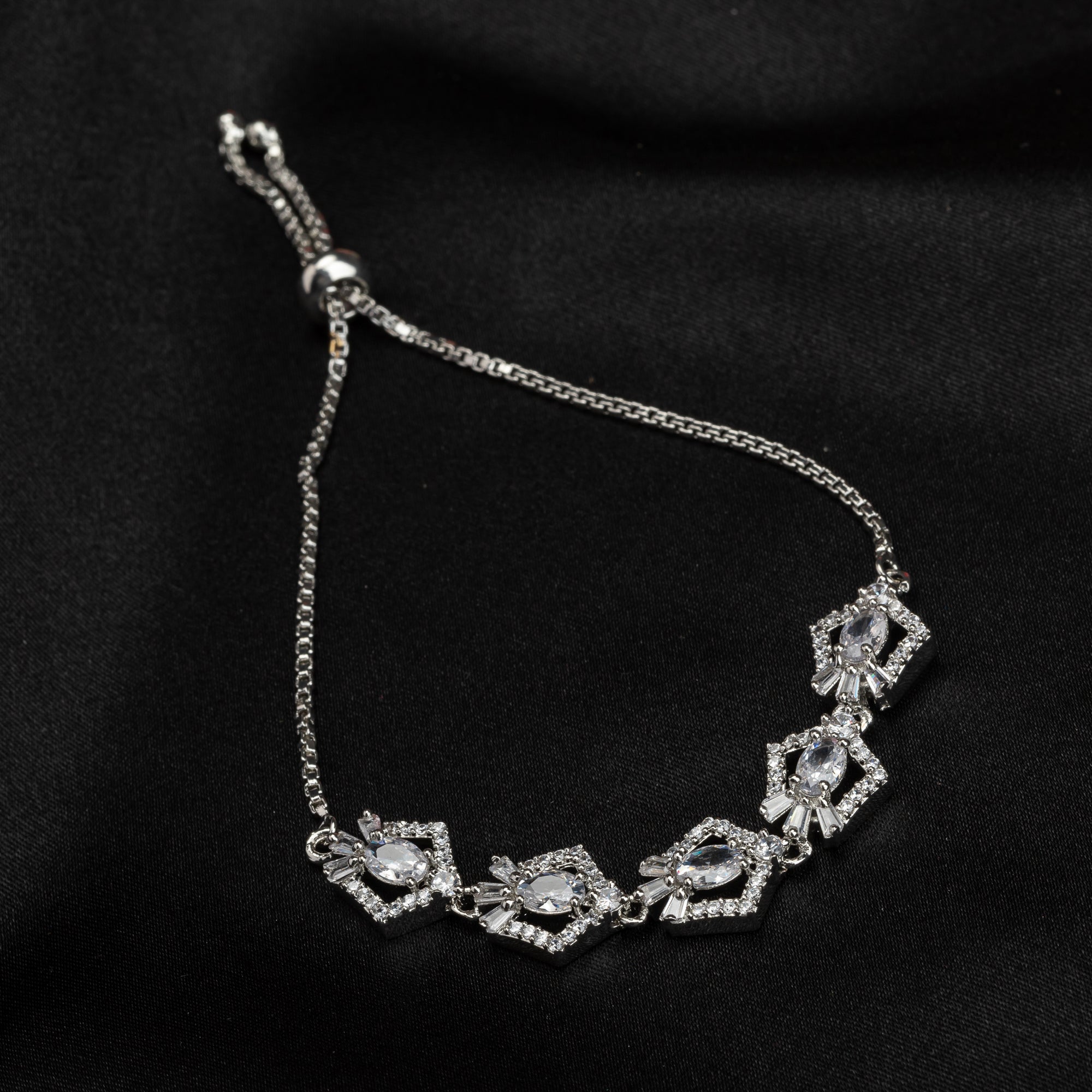 Silver adjustable bracelet with shimmering zircon stones, perfect for a party look.