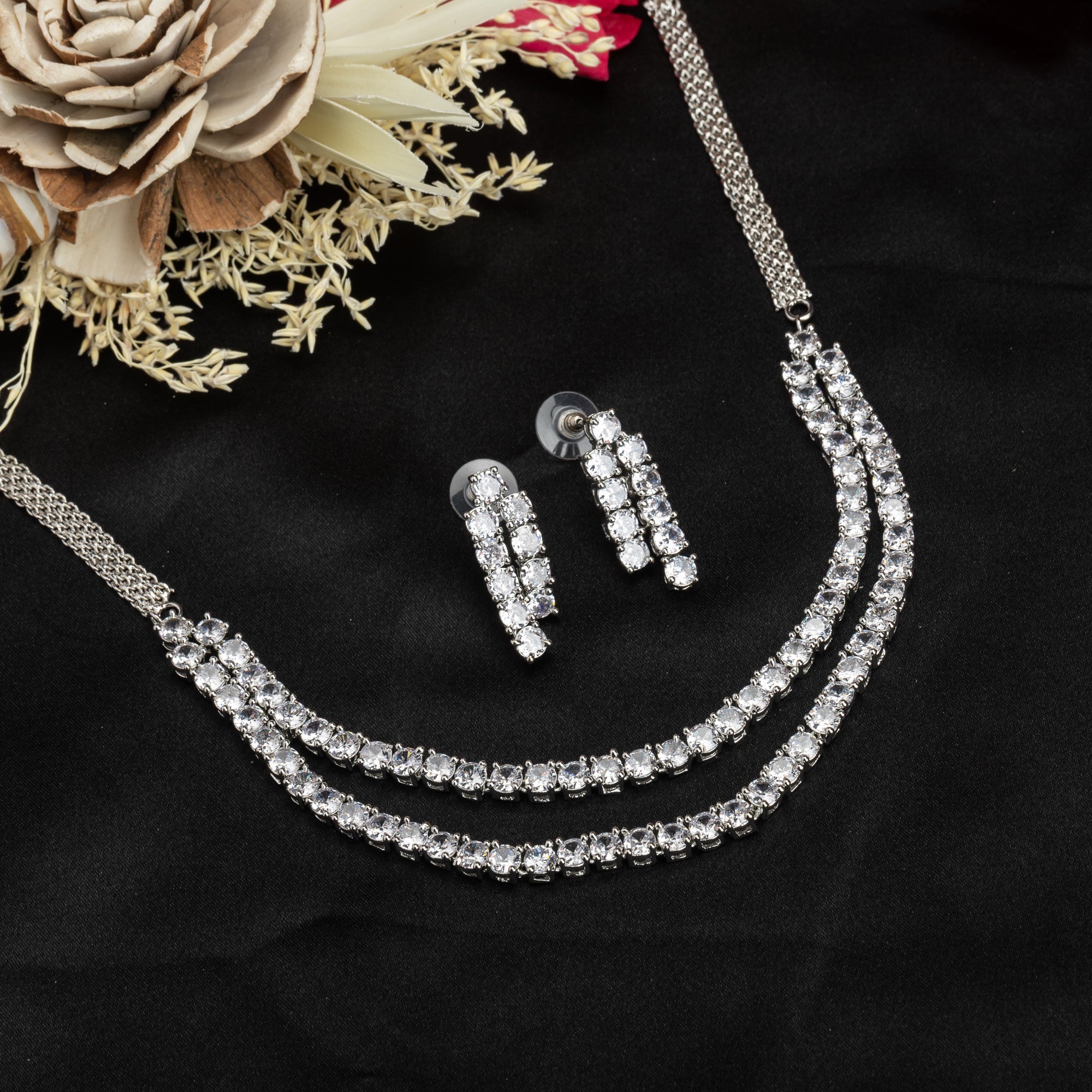 Double-layer silver necklace set with white zircon stones and matching earrings for sophistication.