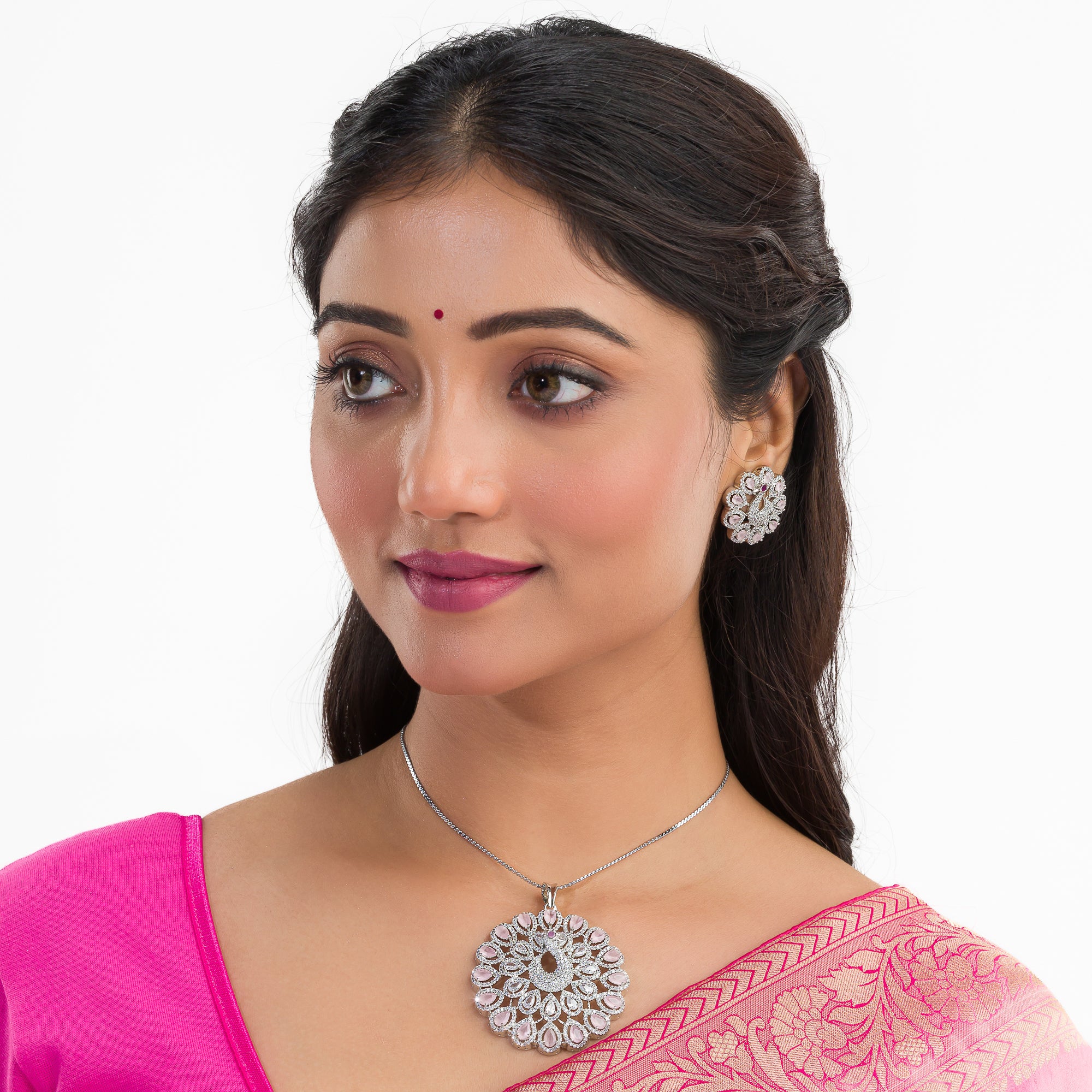 A peacock-designed pendant set with turquoise and white zircon stones is paired with matching earrings.