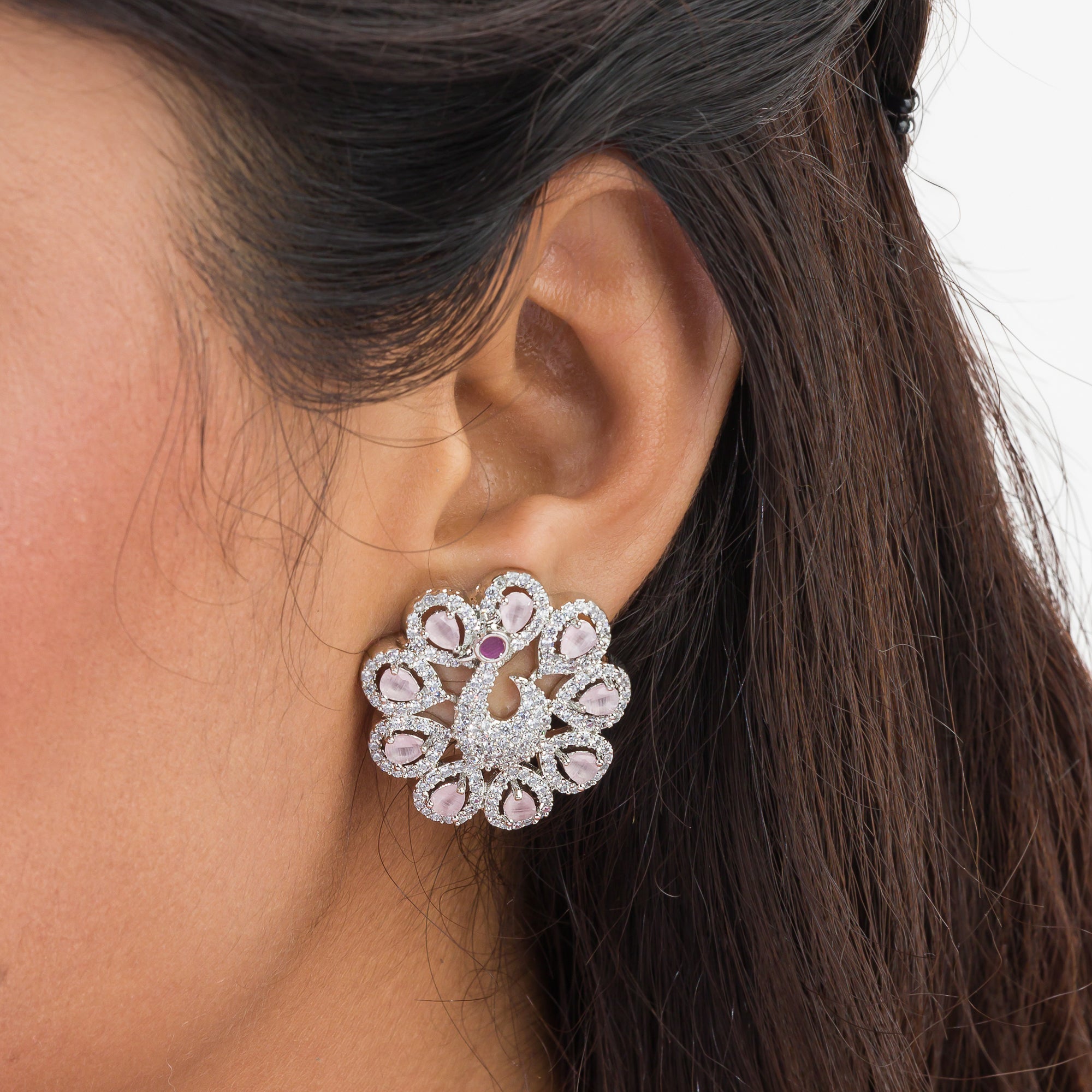 A peacock-designed pendant set with turquoise and white zircon stones is paired with matching earrings.