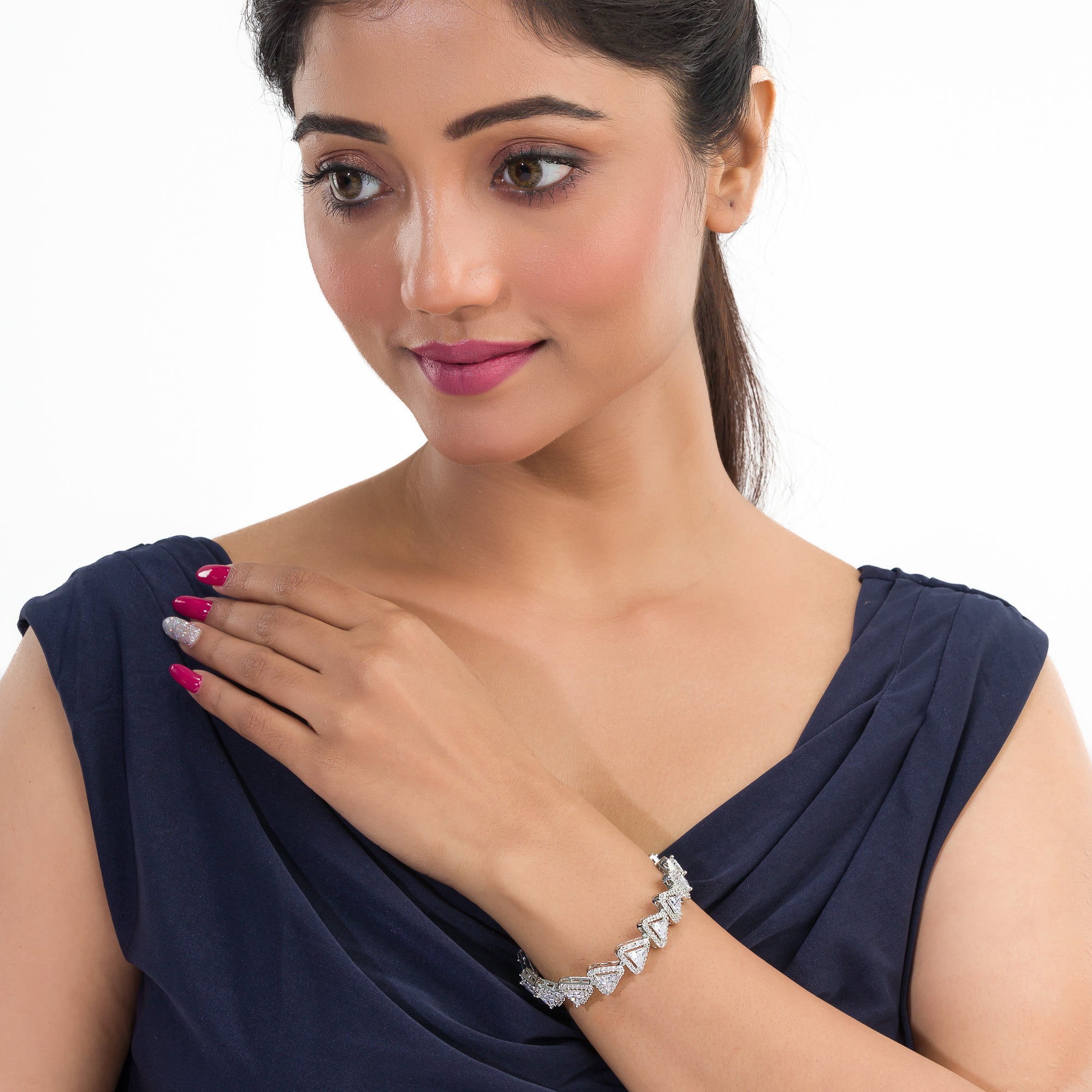 Silver zircon-studded chain bracelet adds sparkle and elegance to your party outfit.