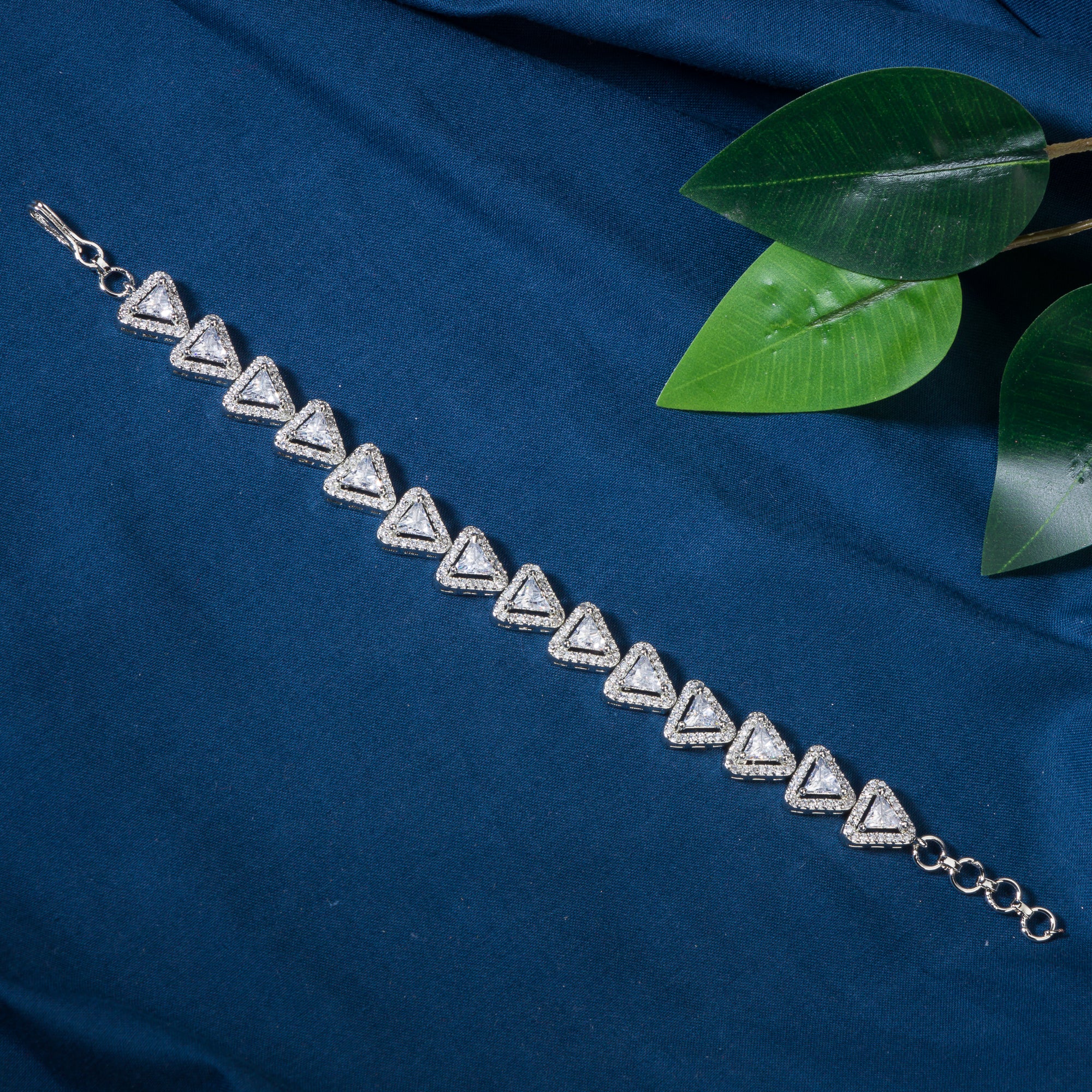 Silver zircon-studded chain bracelet adds sparkle and elegance to your party outfit.