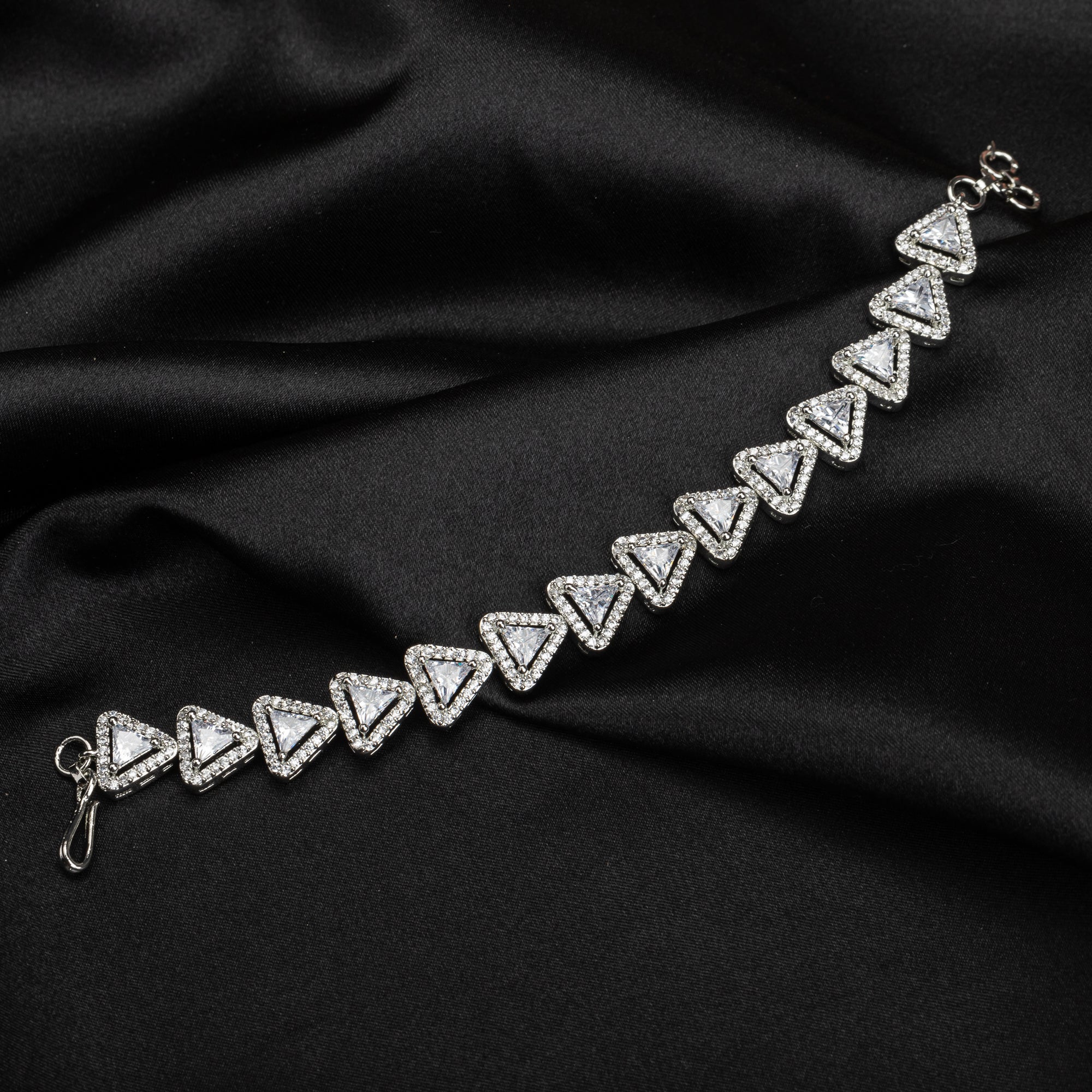 Silver zircon-studded chain bracelet adds sparkle and elegance to your party outfit.