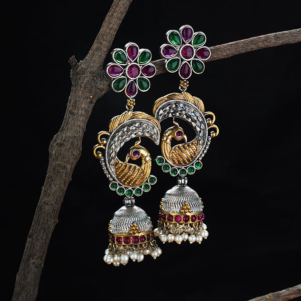 "Long oxidized jhumkas with peacock design, combining traditional elegance and intricate detailing."