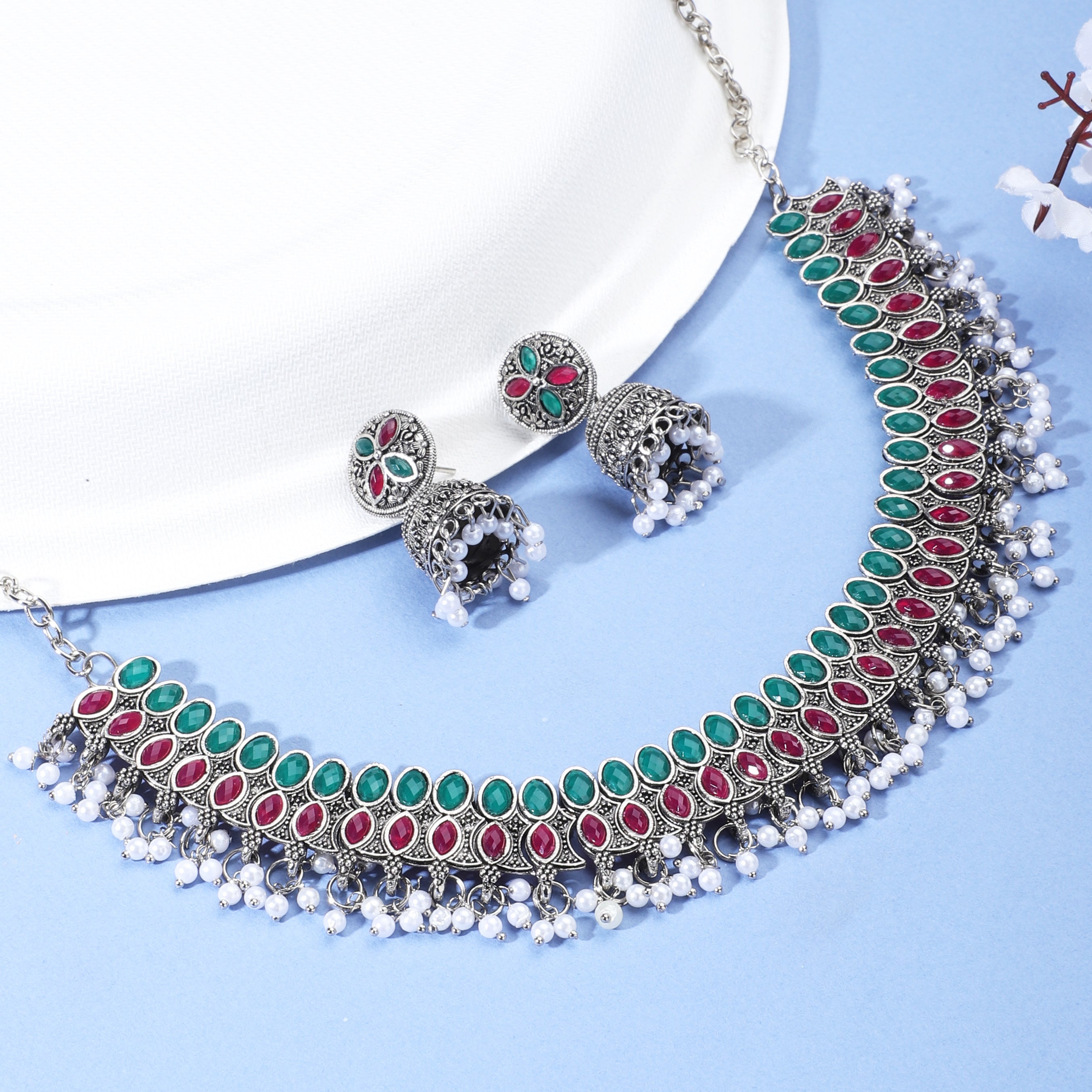 Elegant oxidized necklace set with green and pink stones, paired with matching jhumka earrings.