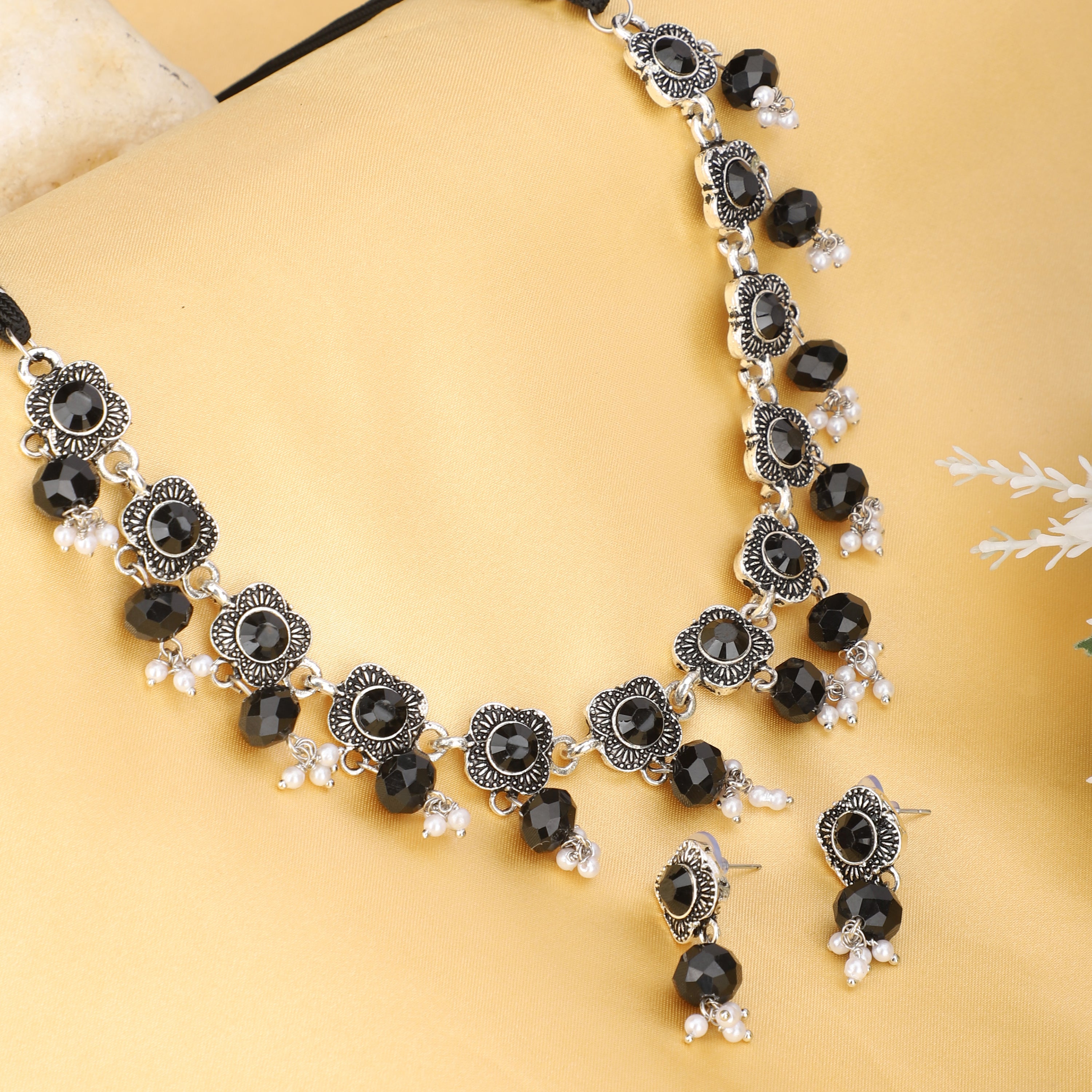Elegant oxidized short necklace set with black stones, offering a bold and sophisticated look.