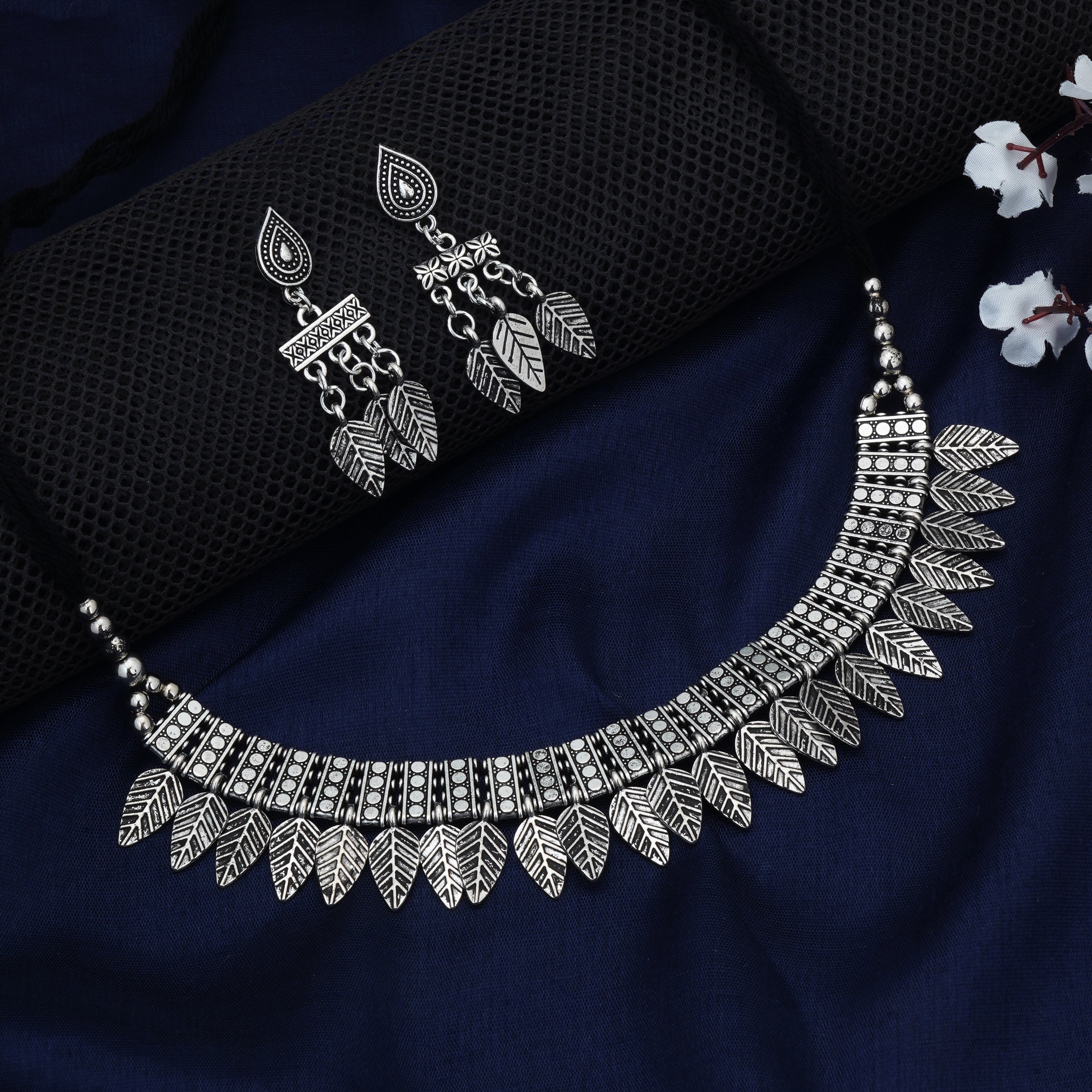 Stylish oxidized short necklace set with intricate leaf designs, perfect for festive elegance.