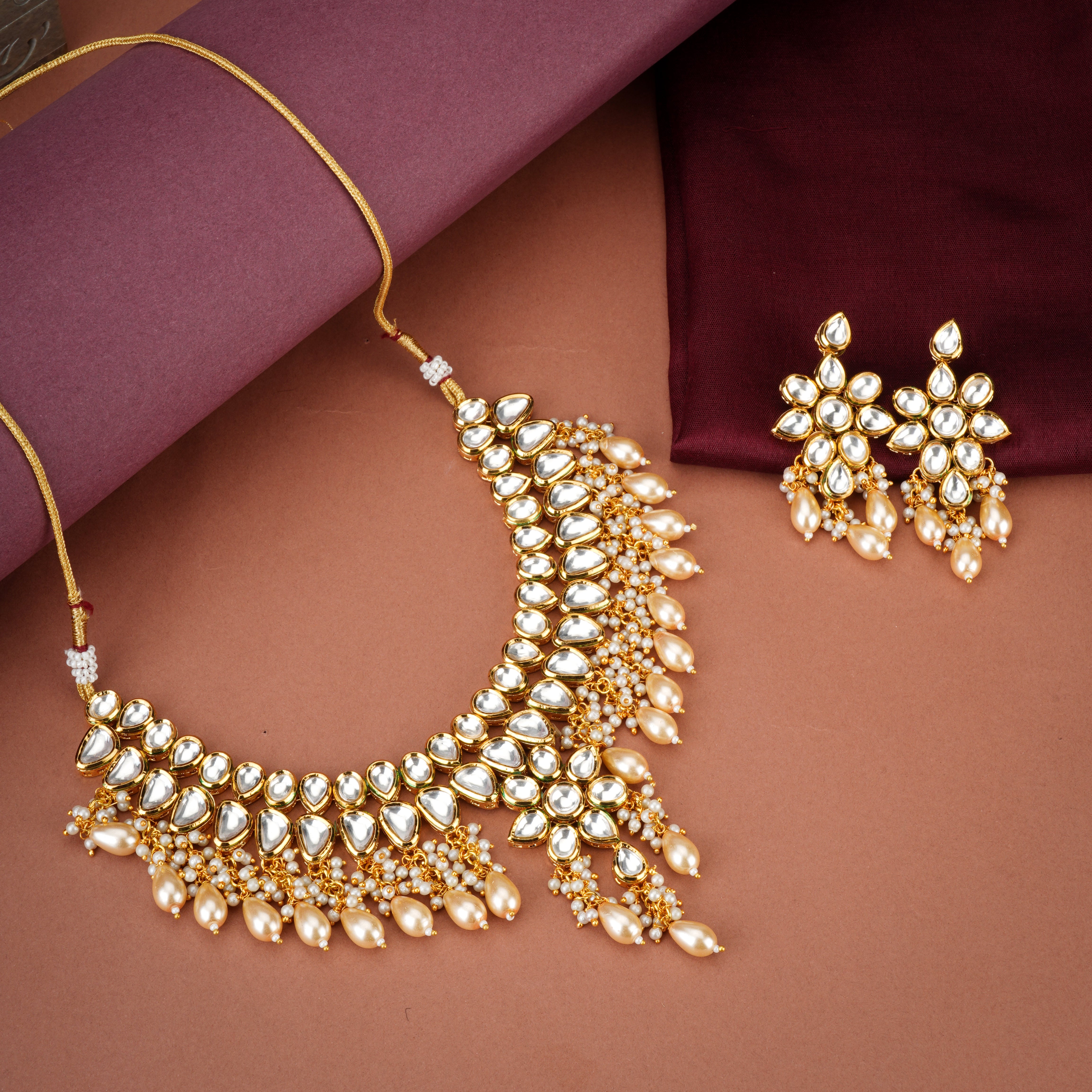 Stunning Kundan choker necklace set with intricate pearl embellishments and craftsmanship.
