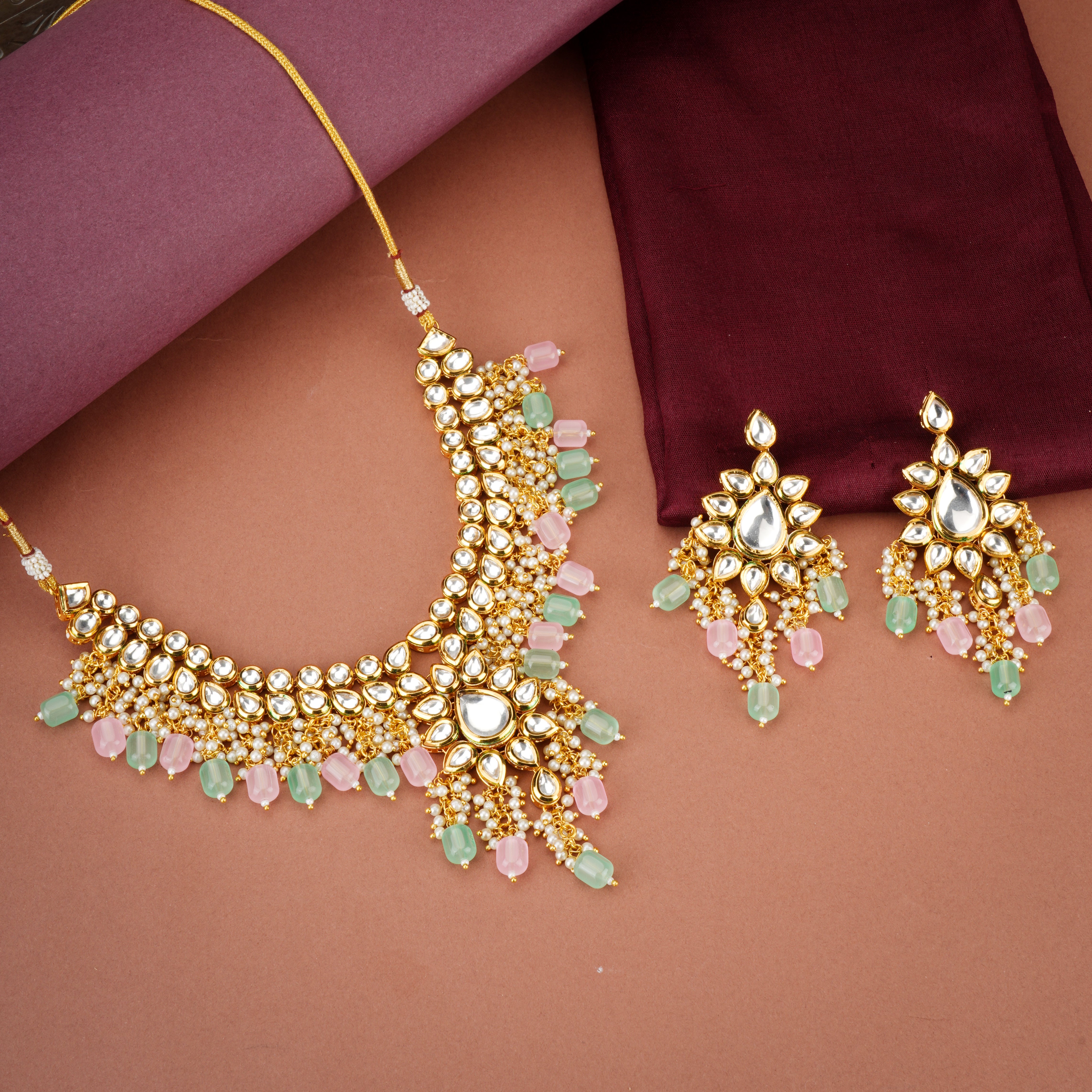 Stunning Kundan choker necklace with exquisite craftsmanship and embedded pearls for bridal look.
