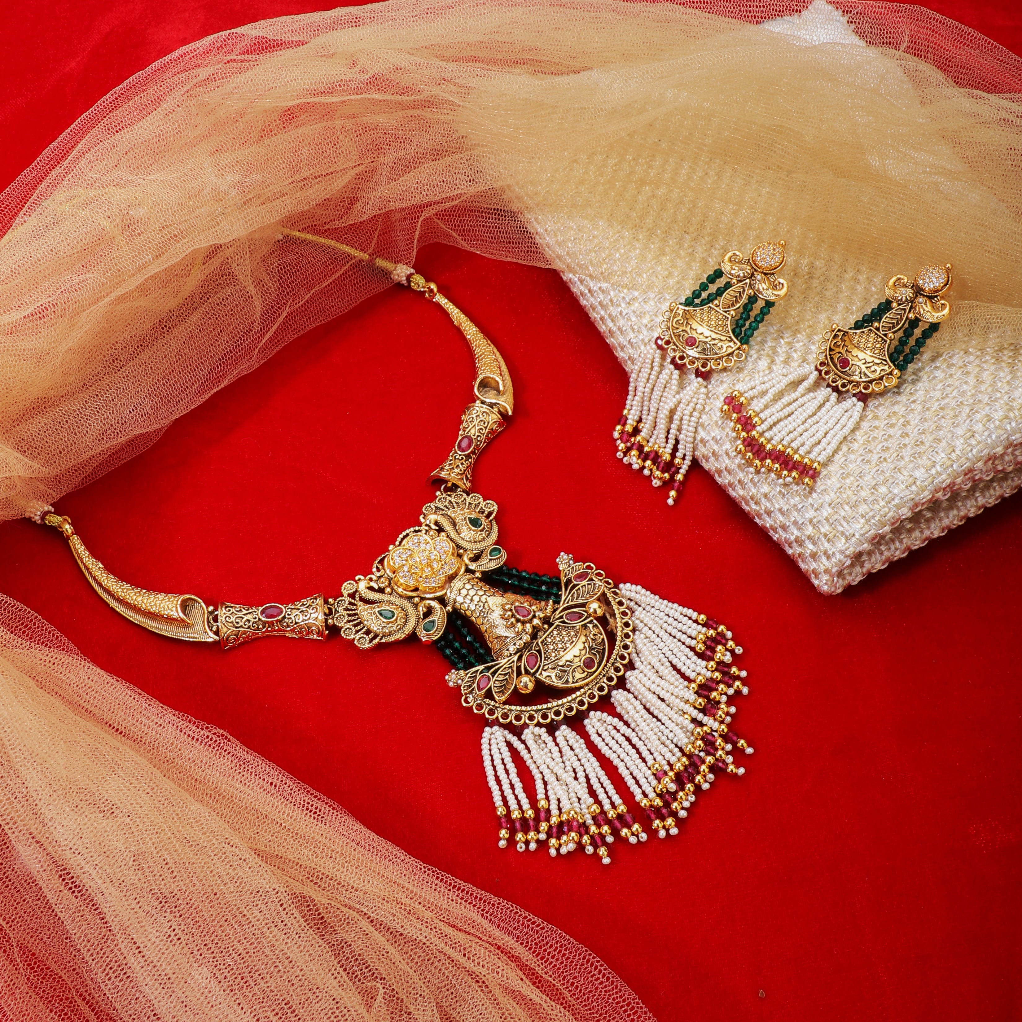 Graceful gold-tone long necklace adorned with pearls, blending tradition with sophistication.