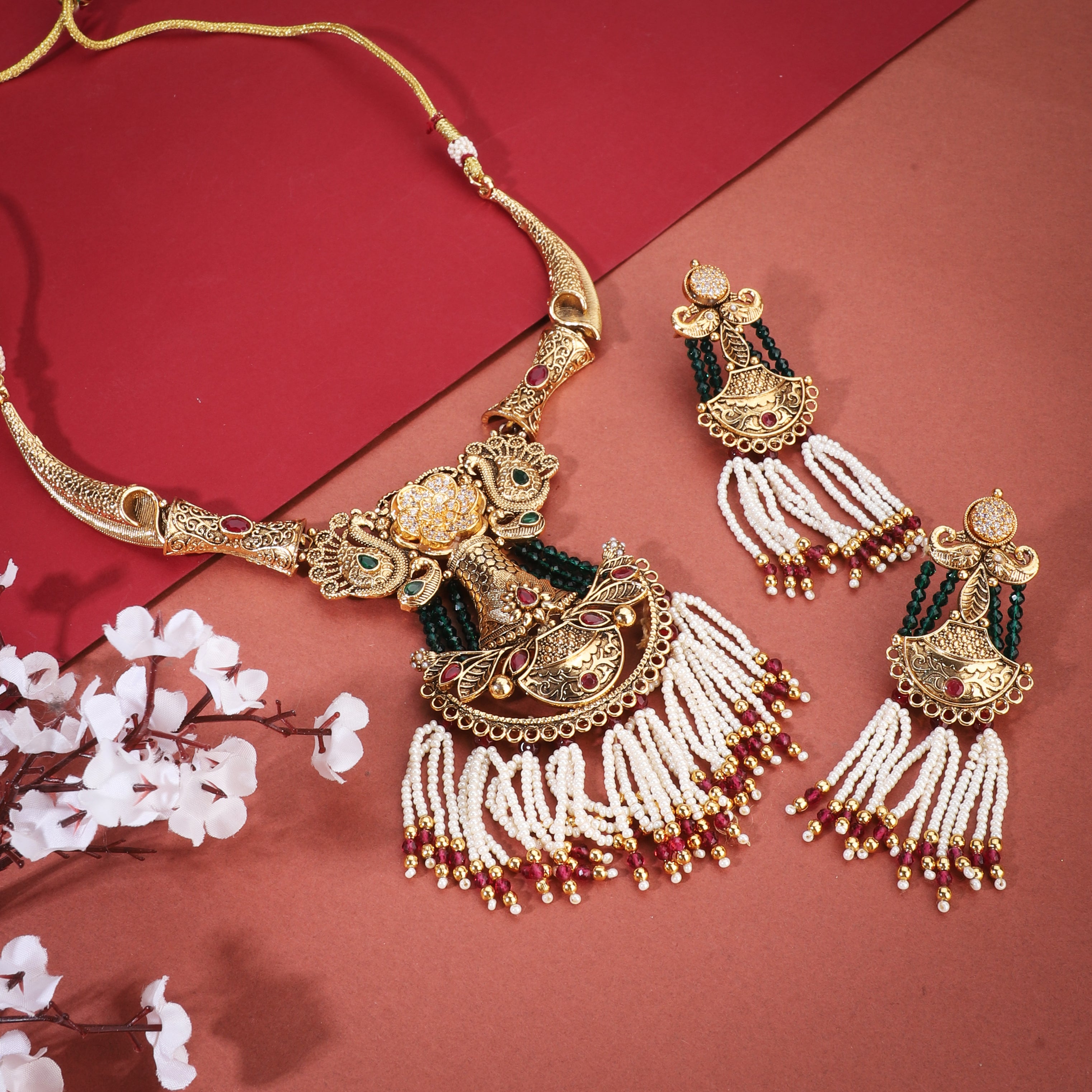 Graceful gold-tone long necklace adorned with pearls, blending tradition with sophistication.