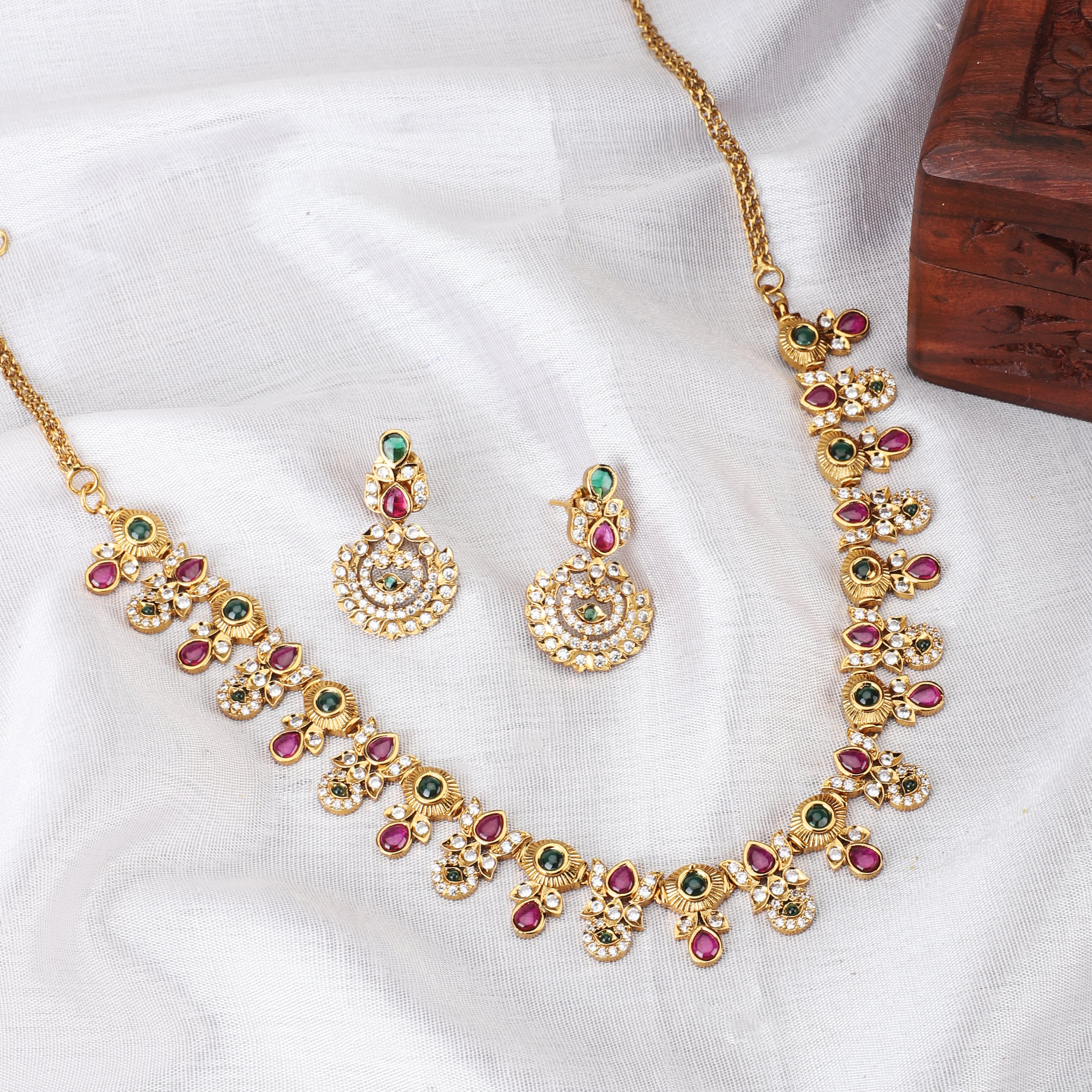Gold-tone short necklace set with vibrant multicolor stones and matching earrings, perfect for celebrations.