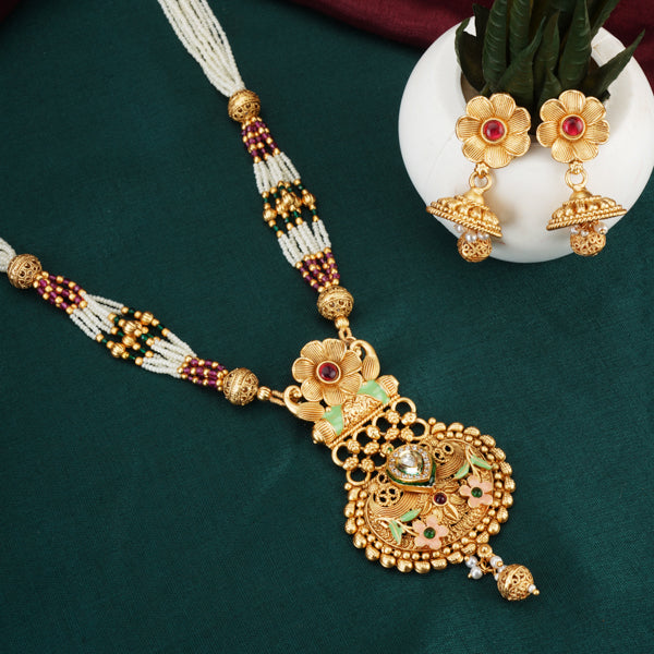 Elegant gold-tone long necklace set with white pearls, offering a classic and refined style."