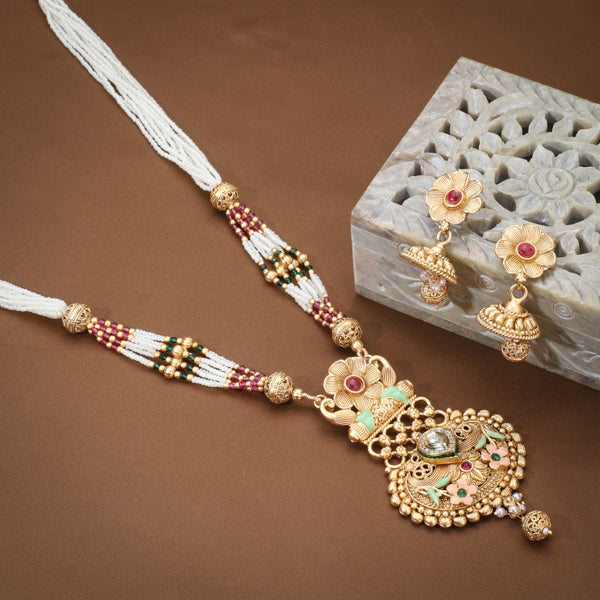 Elegant gold-tone long necklace set with white pearls, offering a classic and refined style."