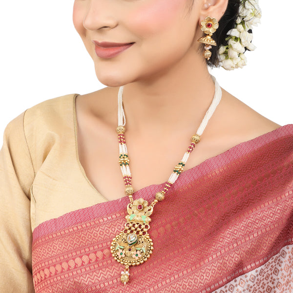 Elegant gold-tone long necklace set with white pearls, offering a classic and refined style."