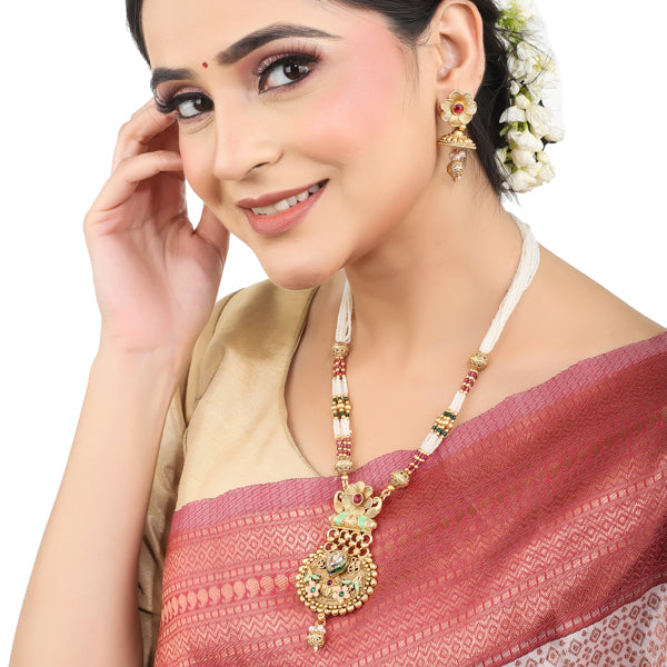 Elegant gold-tone long necklace set with white pearls, offering a classic and refined style."