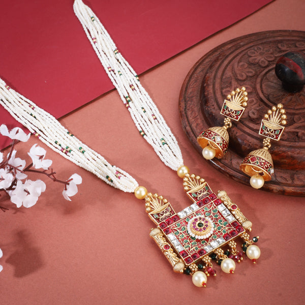 "Graceful gold-tone long necklace with small white pearls, perfect for a sophisticated festive style."