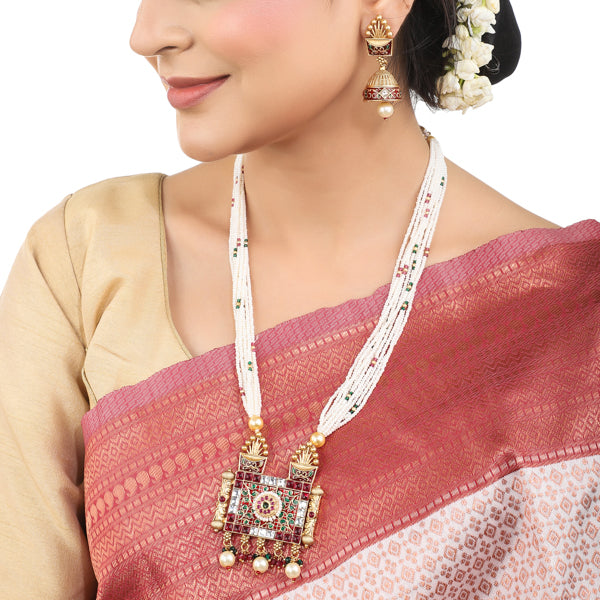 "Graceful gold-tone long necklace with small white pearls, perfect for a sophisticated festive style."