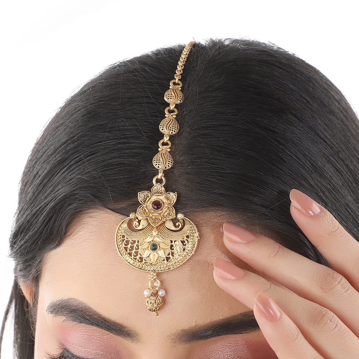 Traditional gold-tone maang tika with a golden finish, ideal for festive and elegant hairstyles.