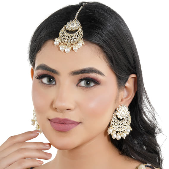 "Classic silver Kundan and pearl-studded earrings with matching Maang Tikka for festive elegance."