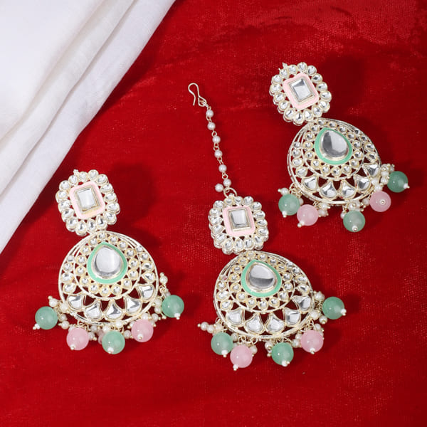 "Festive Kundan and multicolor pearl earrings with matching Maang Tikka, offering an elegant look."