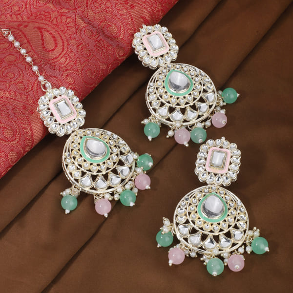 "Festive Kundan and multicolor pearl earrings with matching Maang Tikka, offering an elegant look."