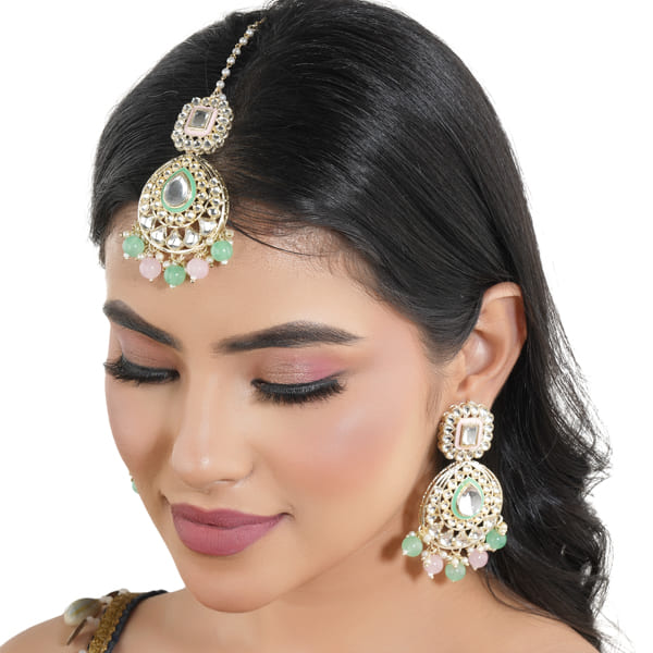 "Festive Kundan and multicolor pearl earrings with matching Maang Tikka, offering an elegant look."