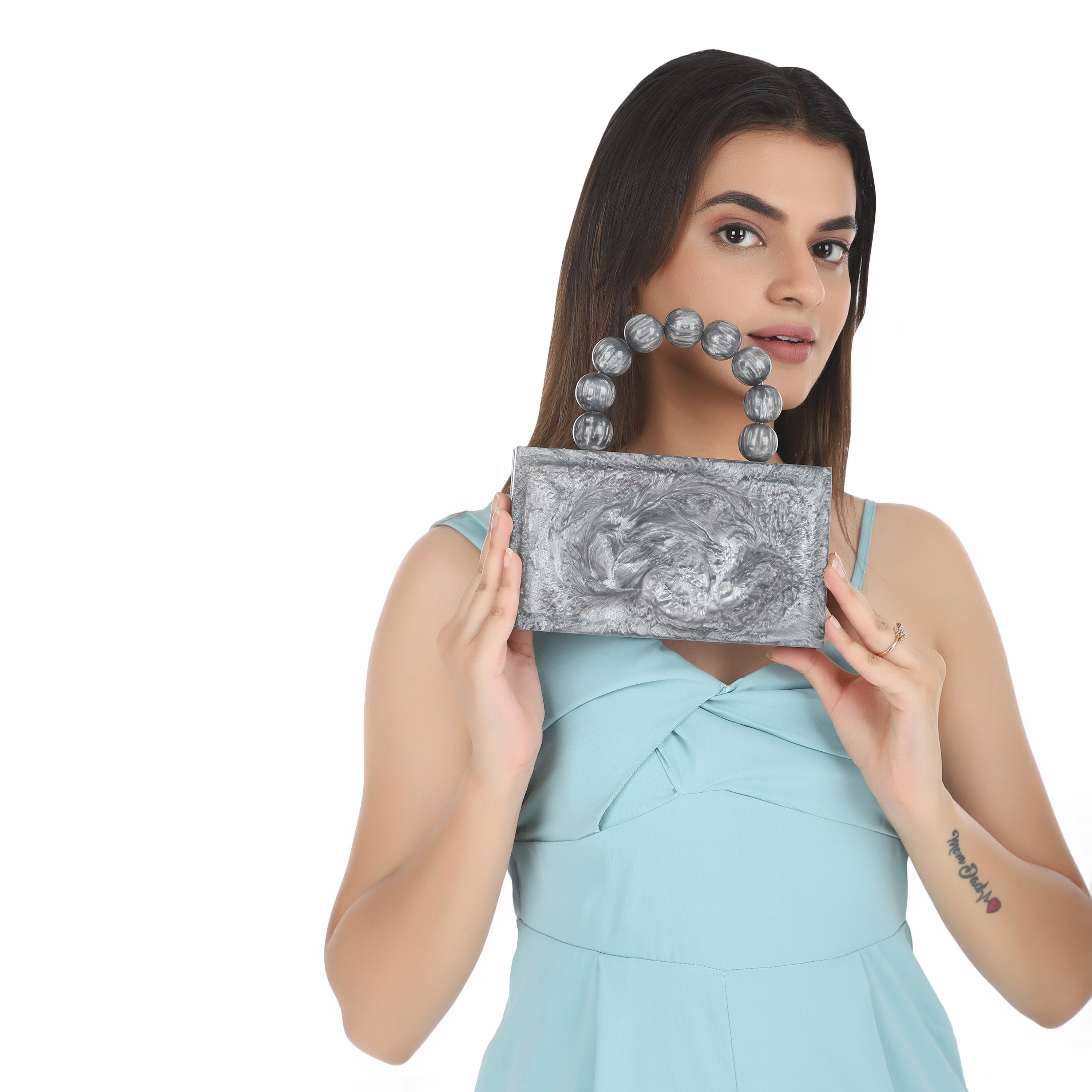 Grey resin clutch with velvet lining, heavy-duty sling, and extra pocket for convenient storage.