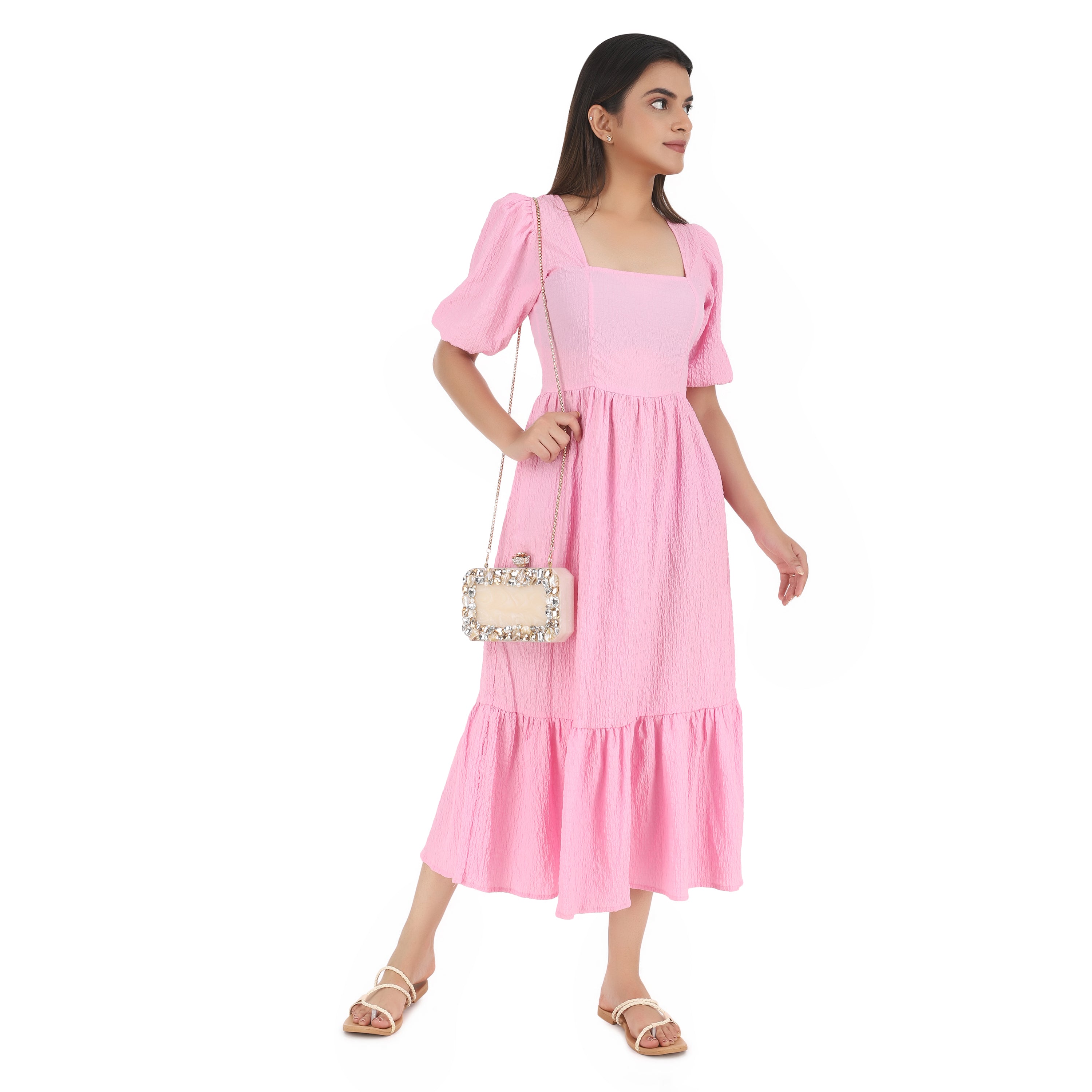 Resin-embellished salmon clutch with rose knob, sturdy sling, and extra pocket for convenience.