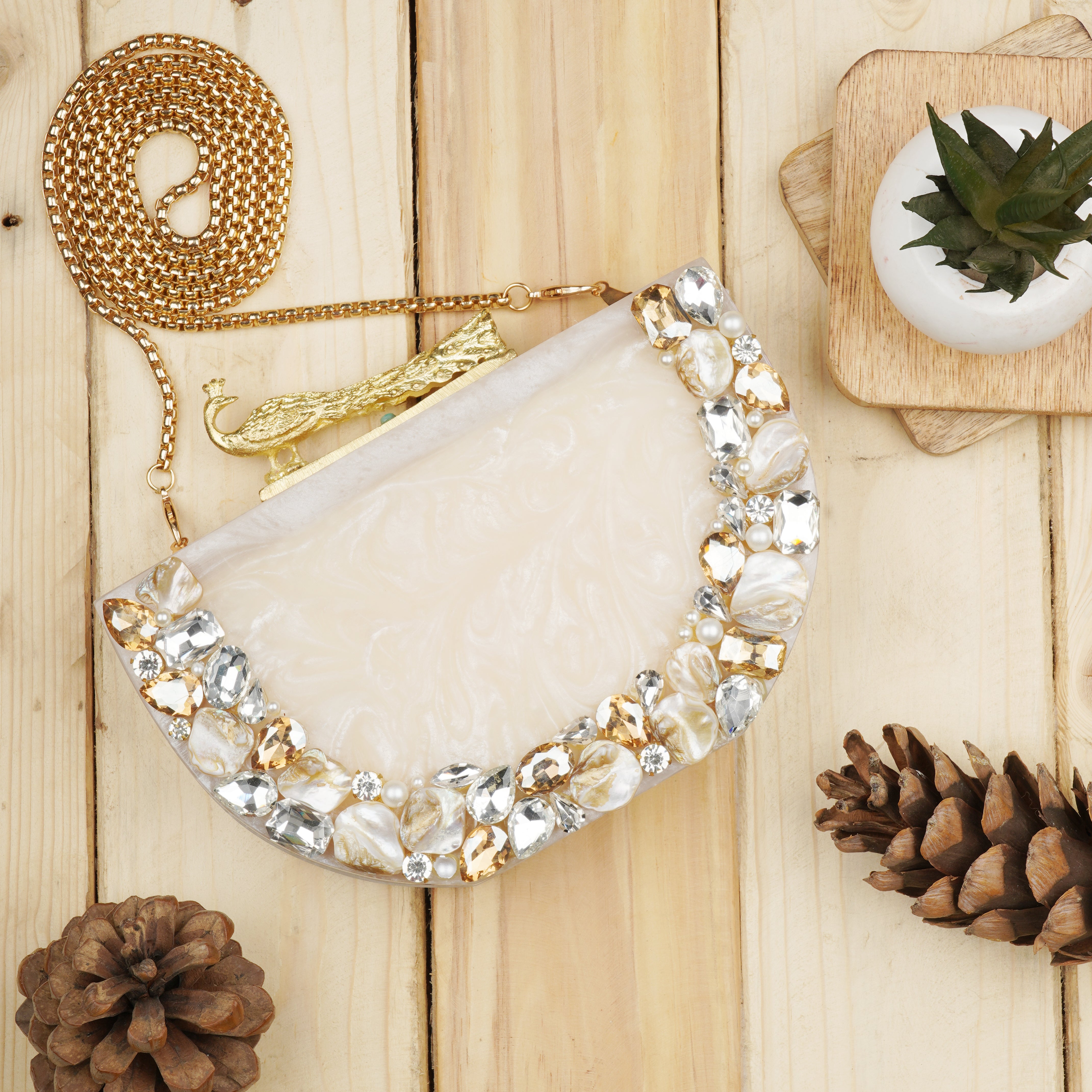 Salmon resin clutch with stone embellishments, soft lining, and extra pocket for storage.