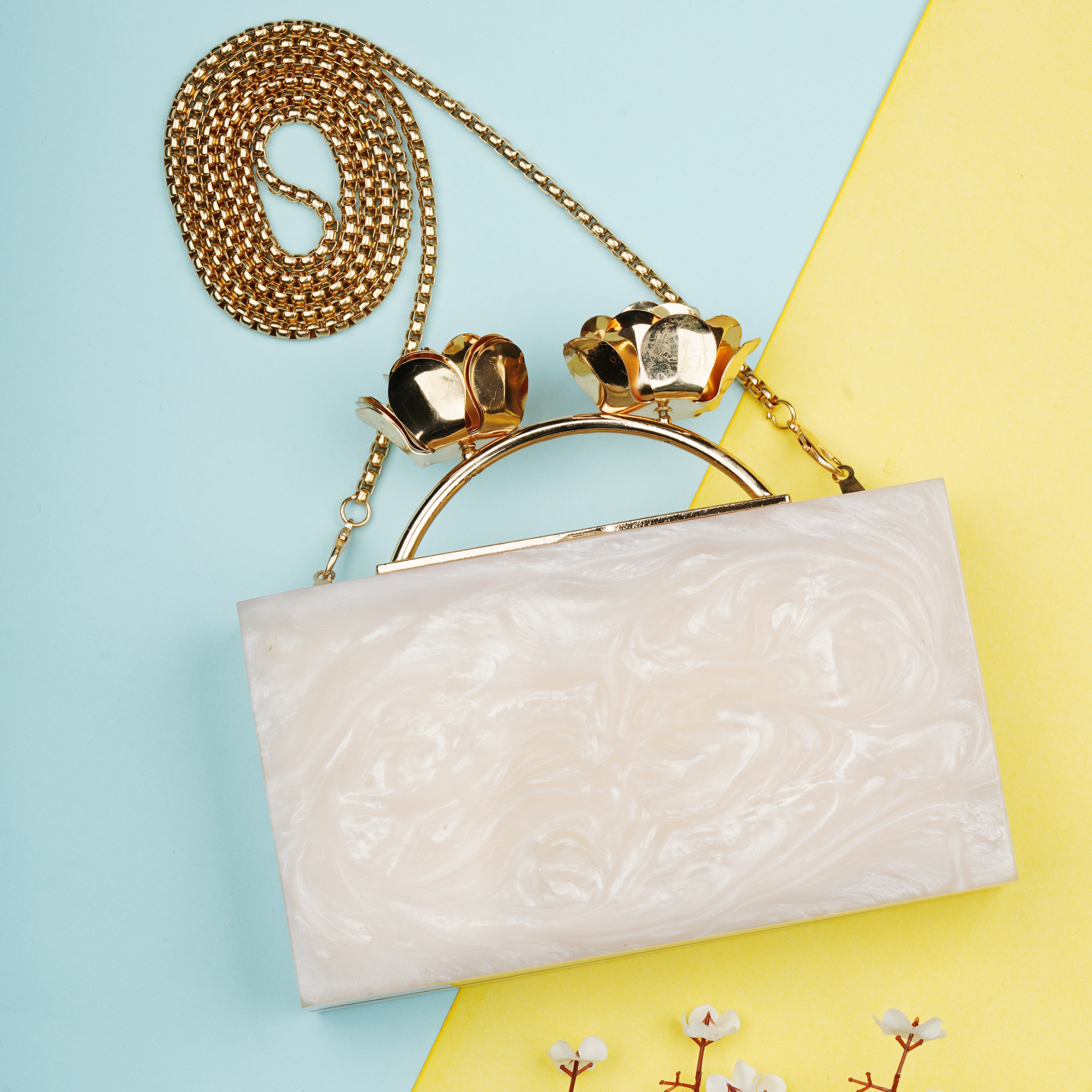 Elegant salmon resin clutch with rose knob, soft lining, and heavy sling for convenience.