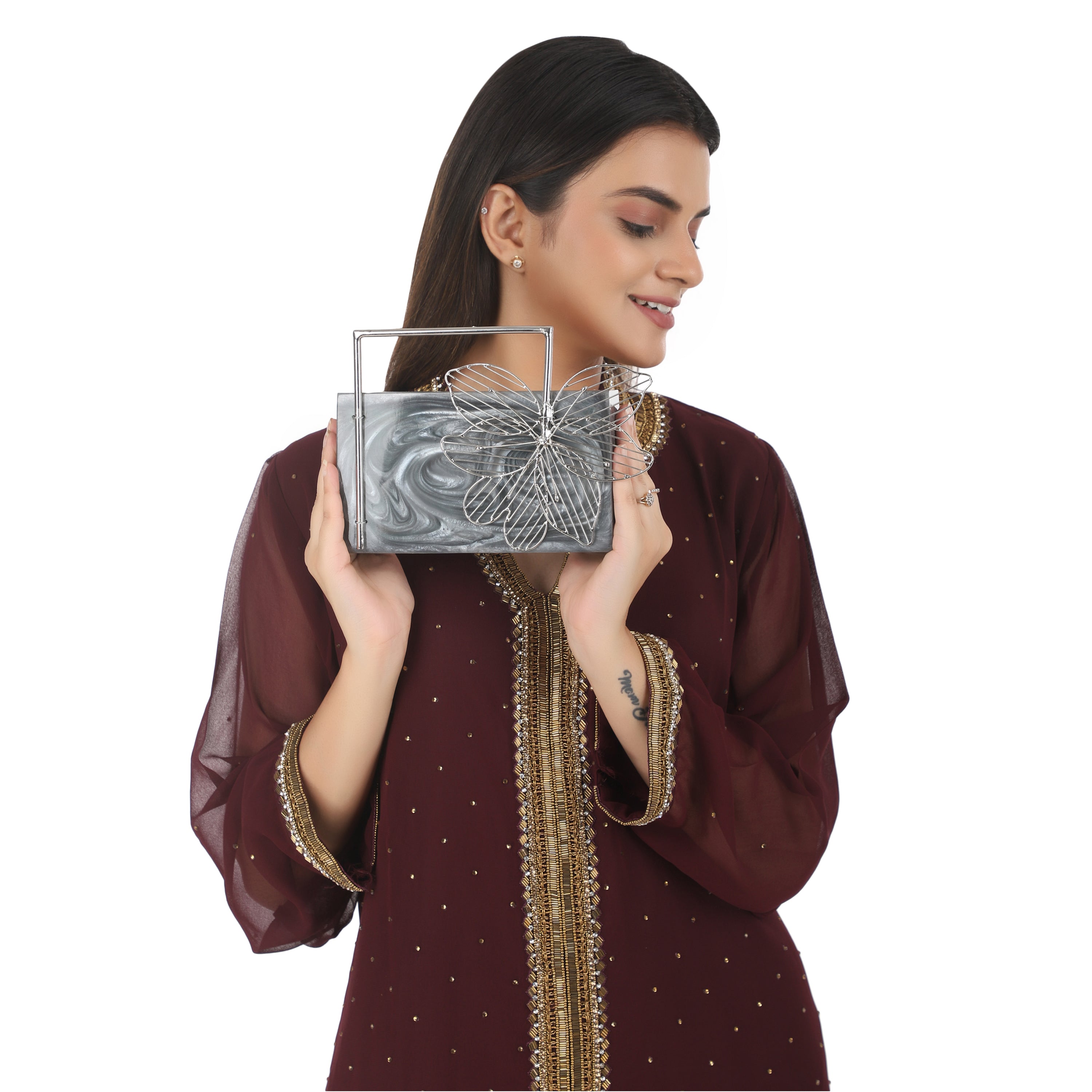 Exclusive grey resin clutch with flower handles, heavy sling, and extra pocket for practicality.