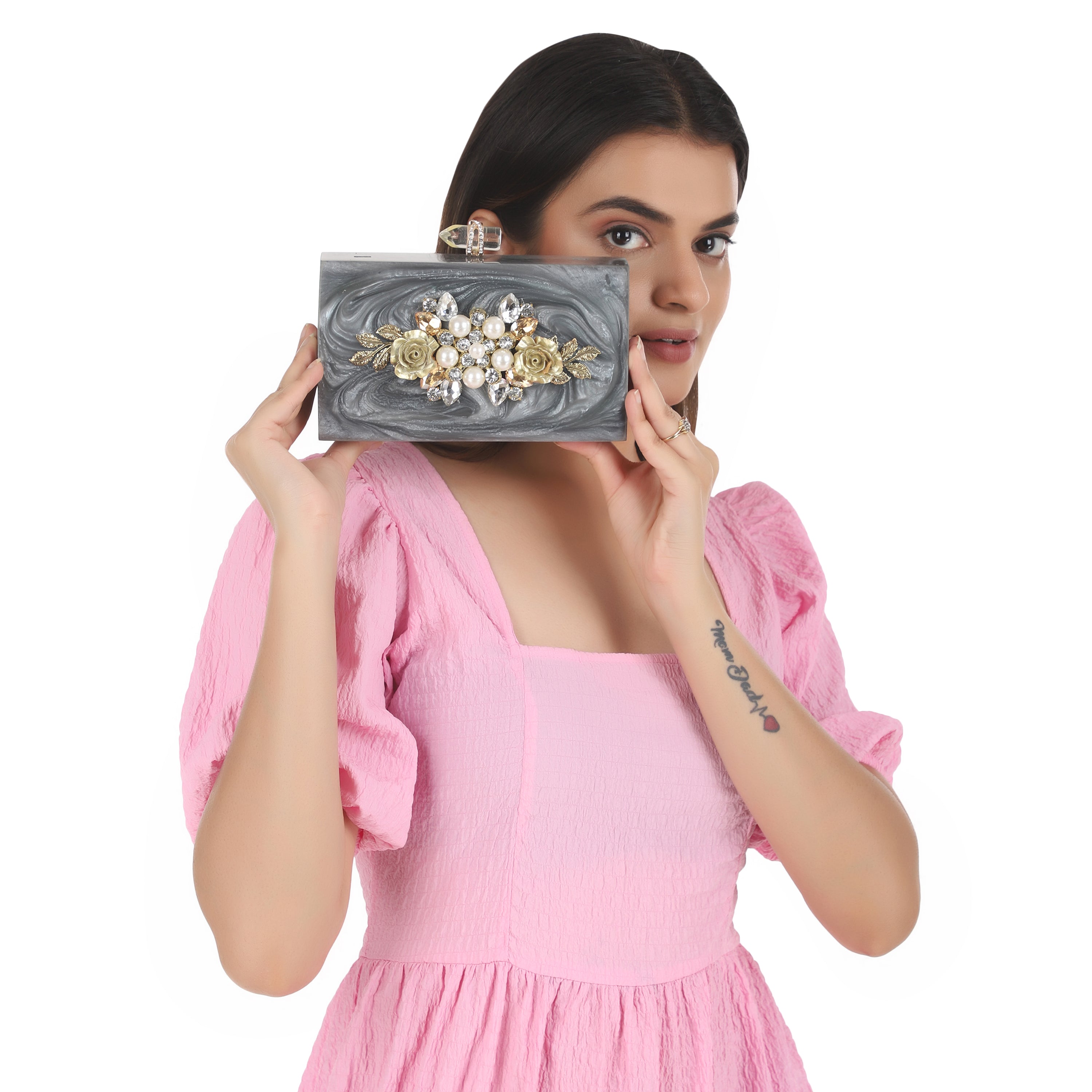 Exclusive grey resin clutch with heavy sling, soft elastic lining, and extra pocket for convenience.