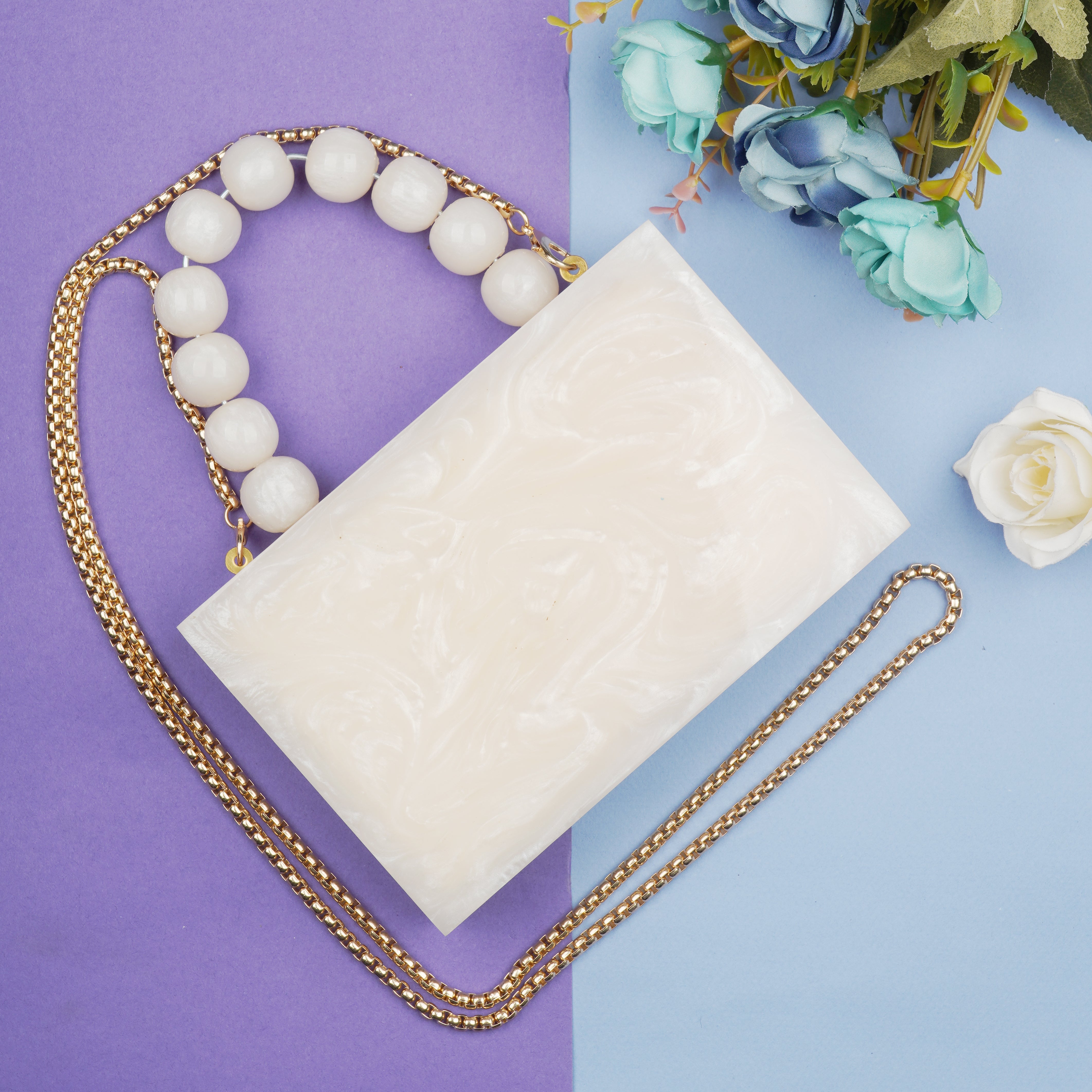 Salmon resin clutch with velvet lining, heavy-duty sling, and extra pocket for convenient storage.