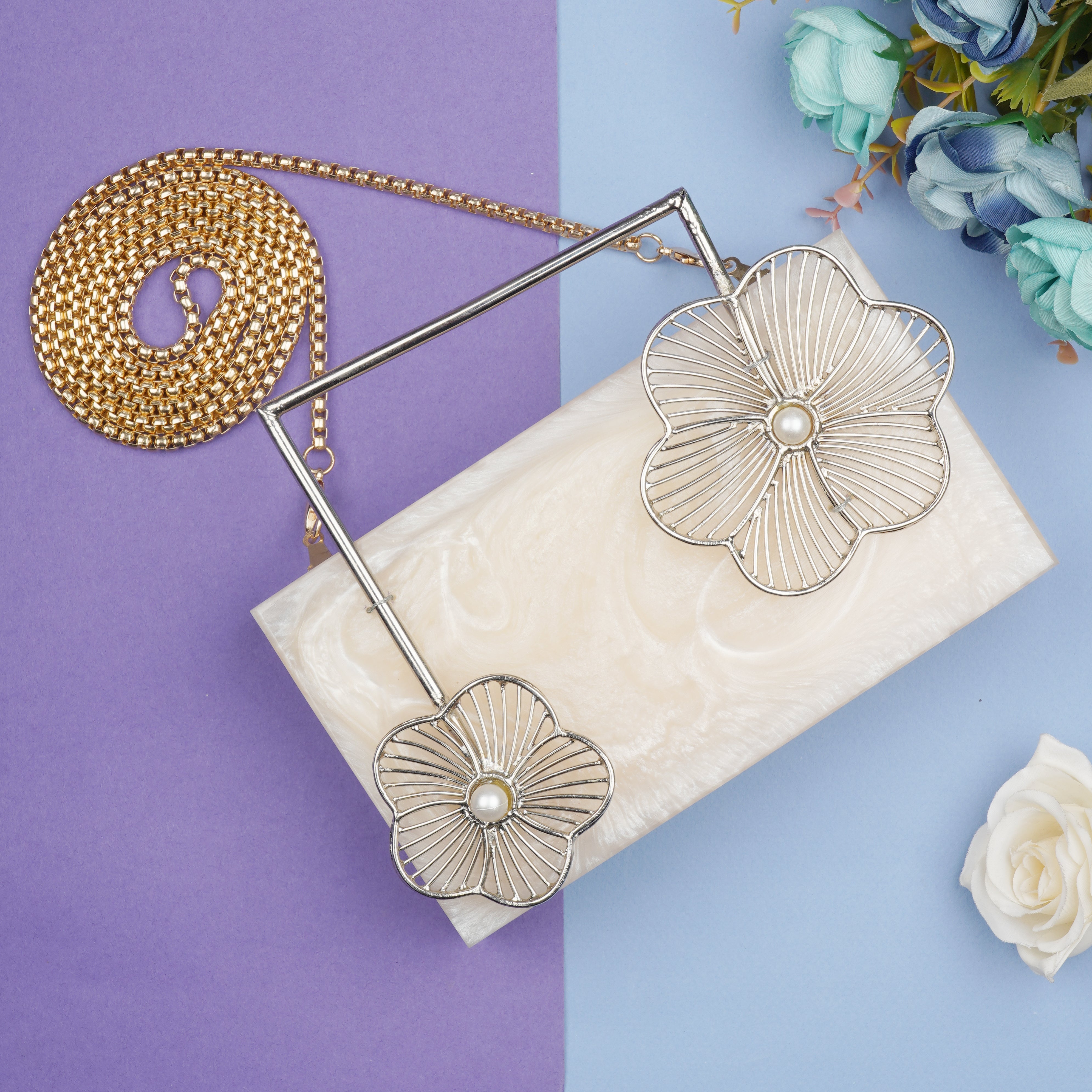 Salmon resin clutch with unique flower handles, heavy sling, and extra pocket for convenience.