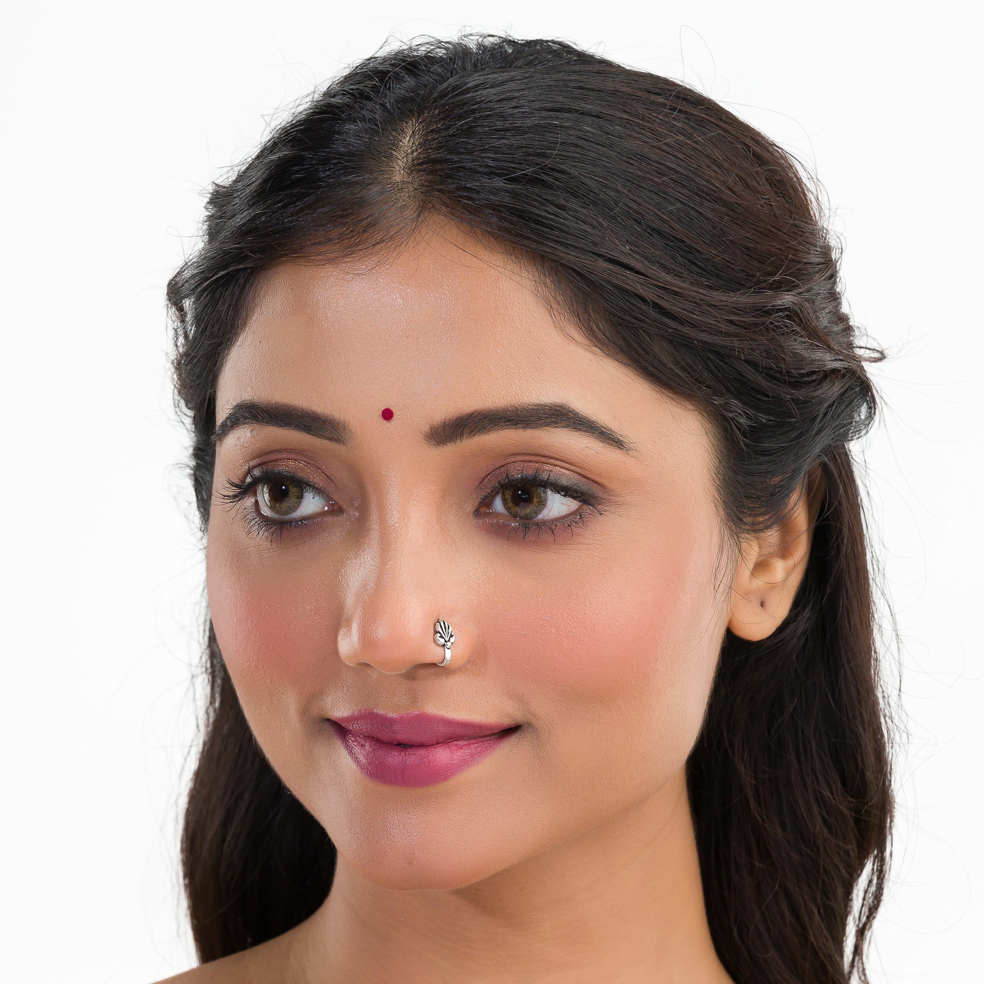 "Small oxidized silver nose pin, perfect for festival wear, adding a delicate, vintage touch."
