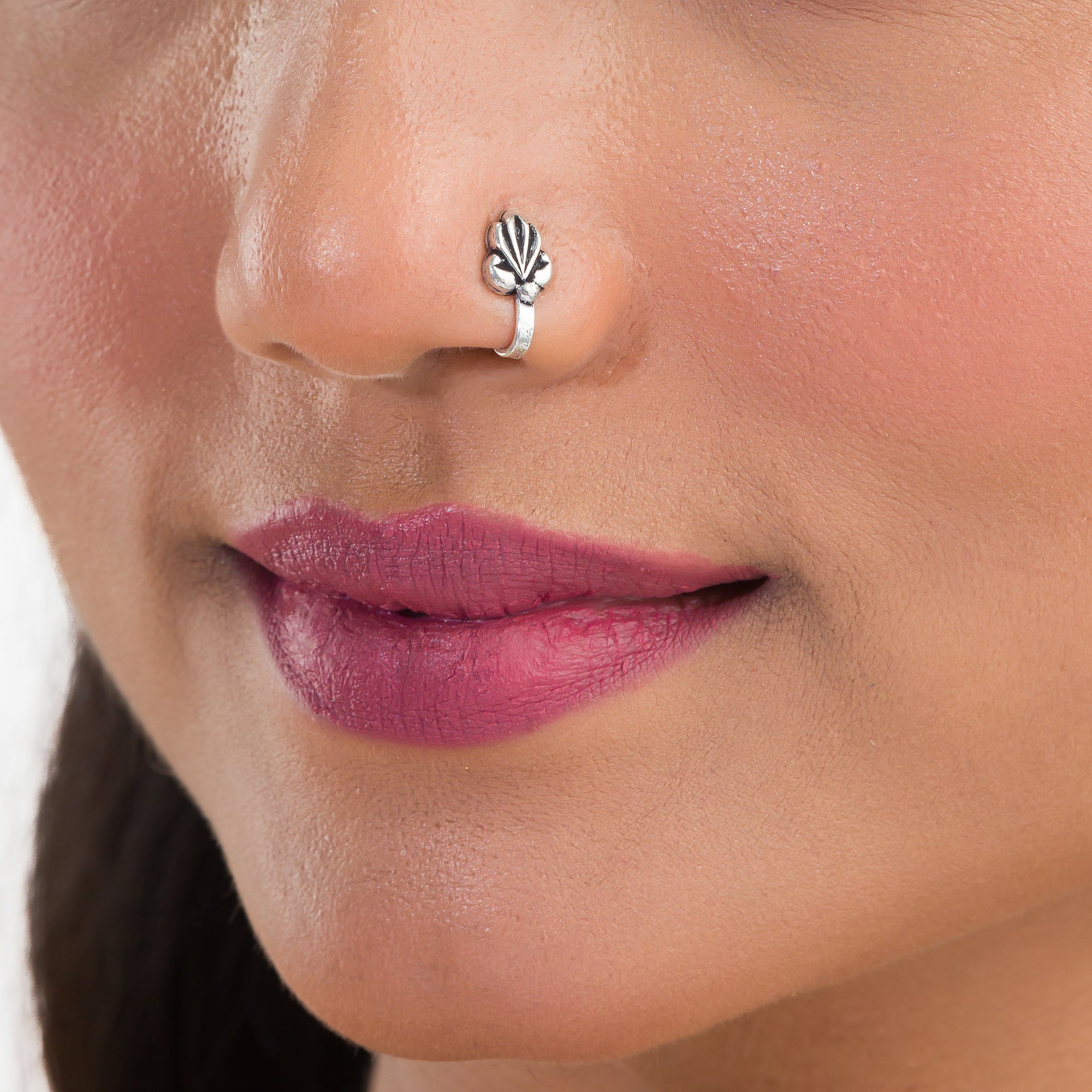 "Small oxidized silver nose pin, perfect for festival wear, adding a delicate, vintage touch."
