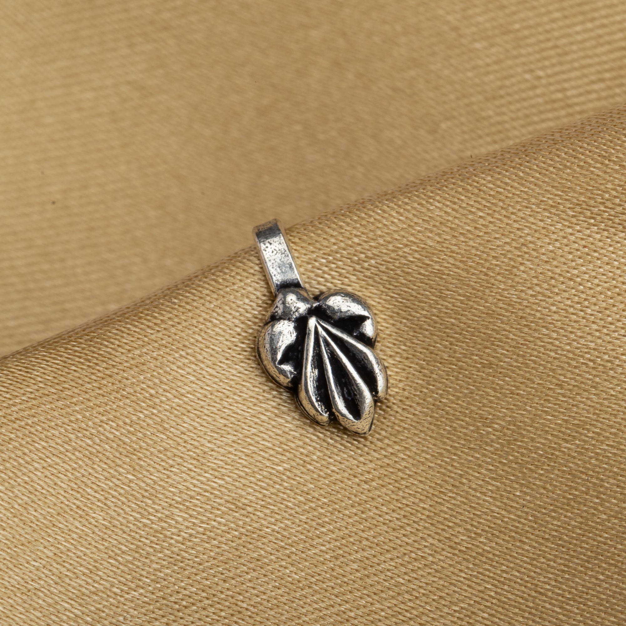 "Small oxidized silver nose pin, perfect for festival wear, adding a delicate, vintage touch."
