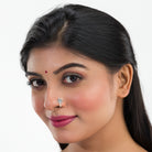 "Refined oxidized silver nose pin for festival wear, adding a retro touch with its darkened finish."
