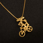 "Gold-tone pendant featuring a boy riding a bicycle, perfect for casual wear, with a fun and unique design."
