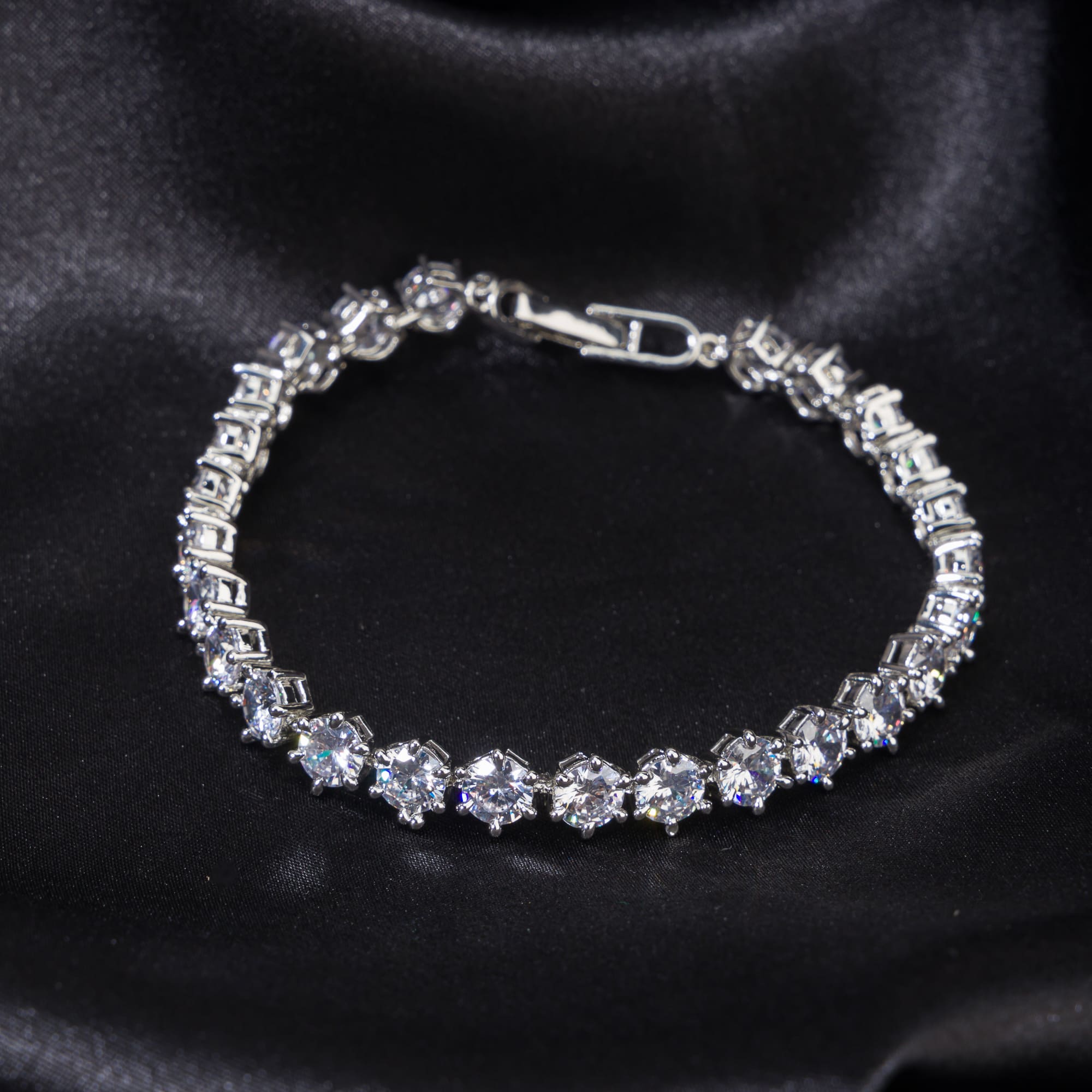 Stunning zircon stone chain bracelet in silver, perfect for party wear, adding sparkle and elegance."
