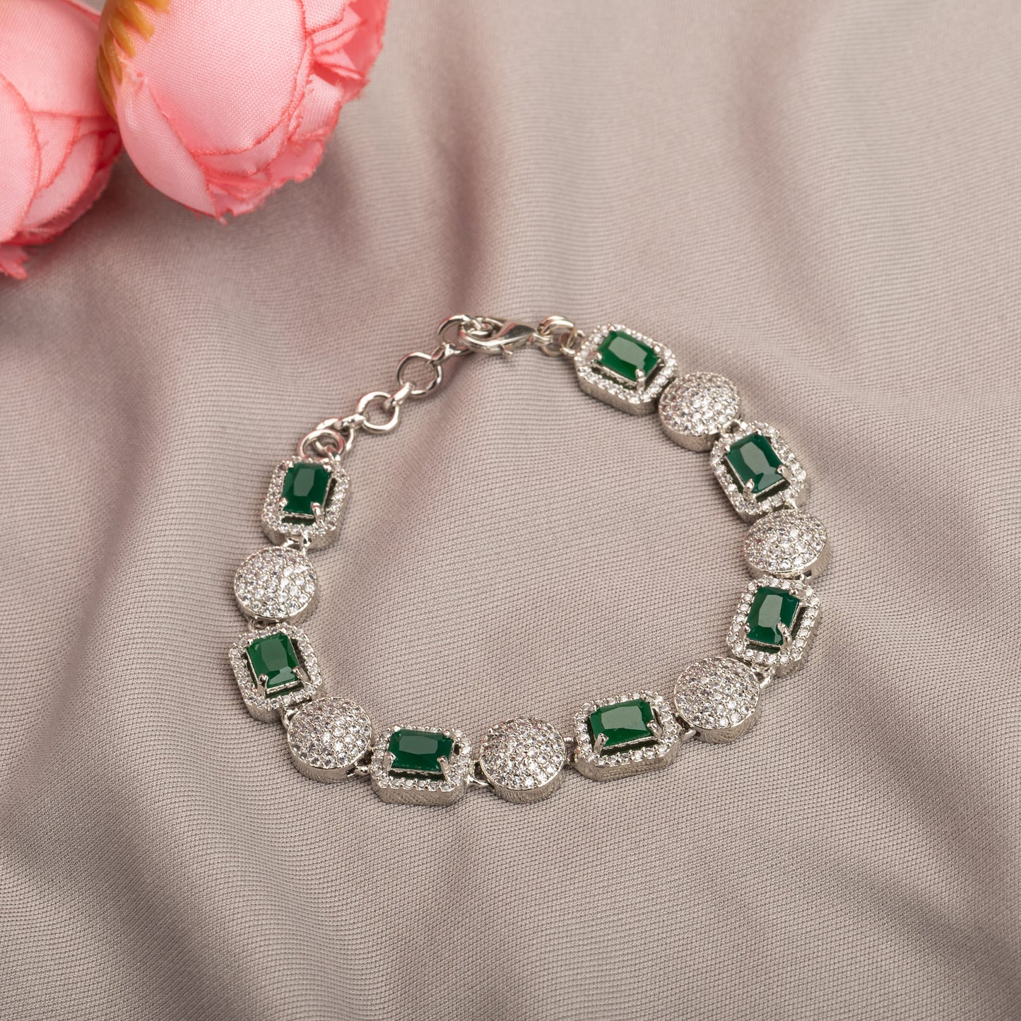 A CHAIN ZIRCON BRACELET WITH GREEN AND ZIRCON STONES COMBINES DELICATE ELEGANCE WITH VIBRANT COLOR AND SPARKLE.