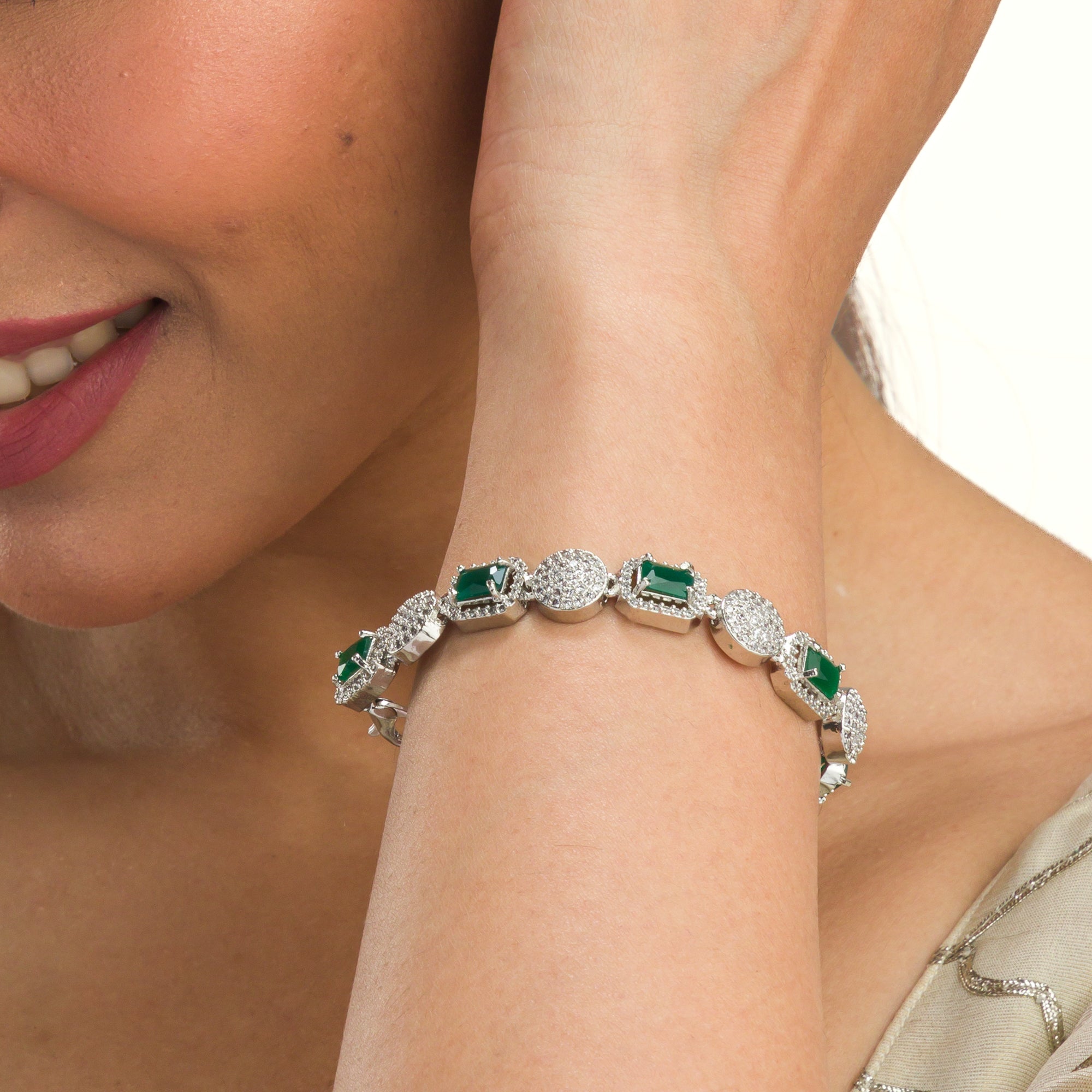 Elegant zircon bracelet with green stones, combining delicate sparkle with vibrant color for party wear."
